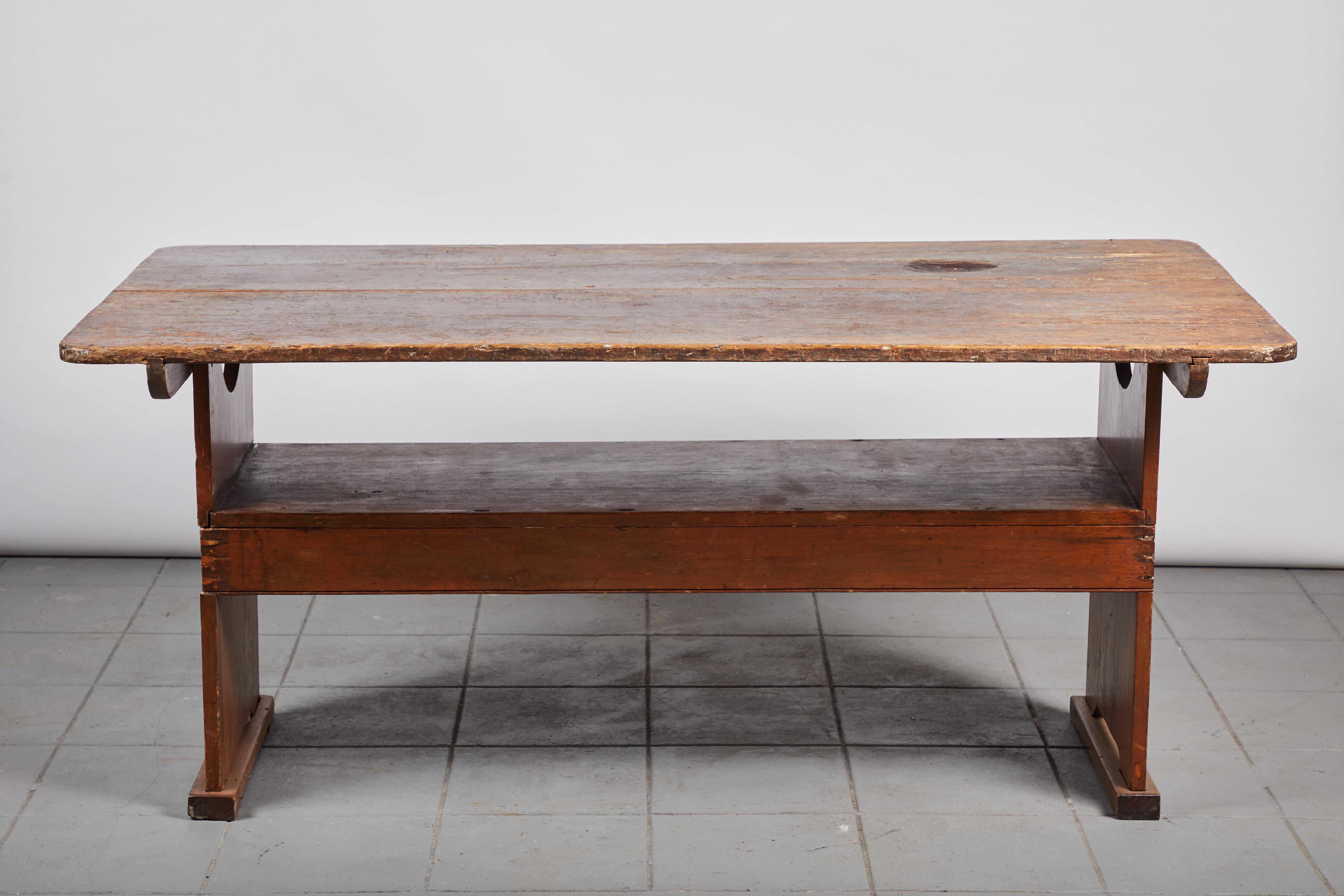 Early American Shaker dining table that pivots up to be a bench. The bench has a seat height of 18