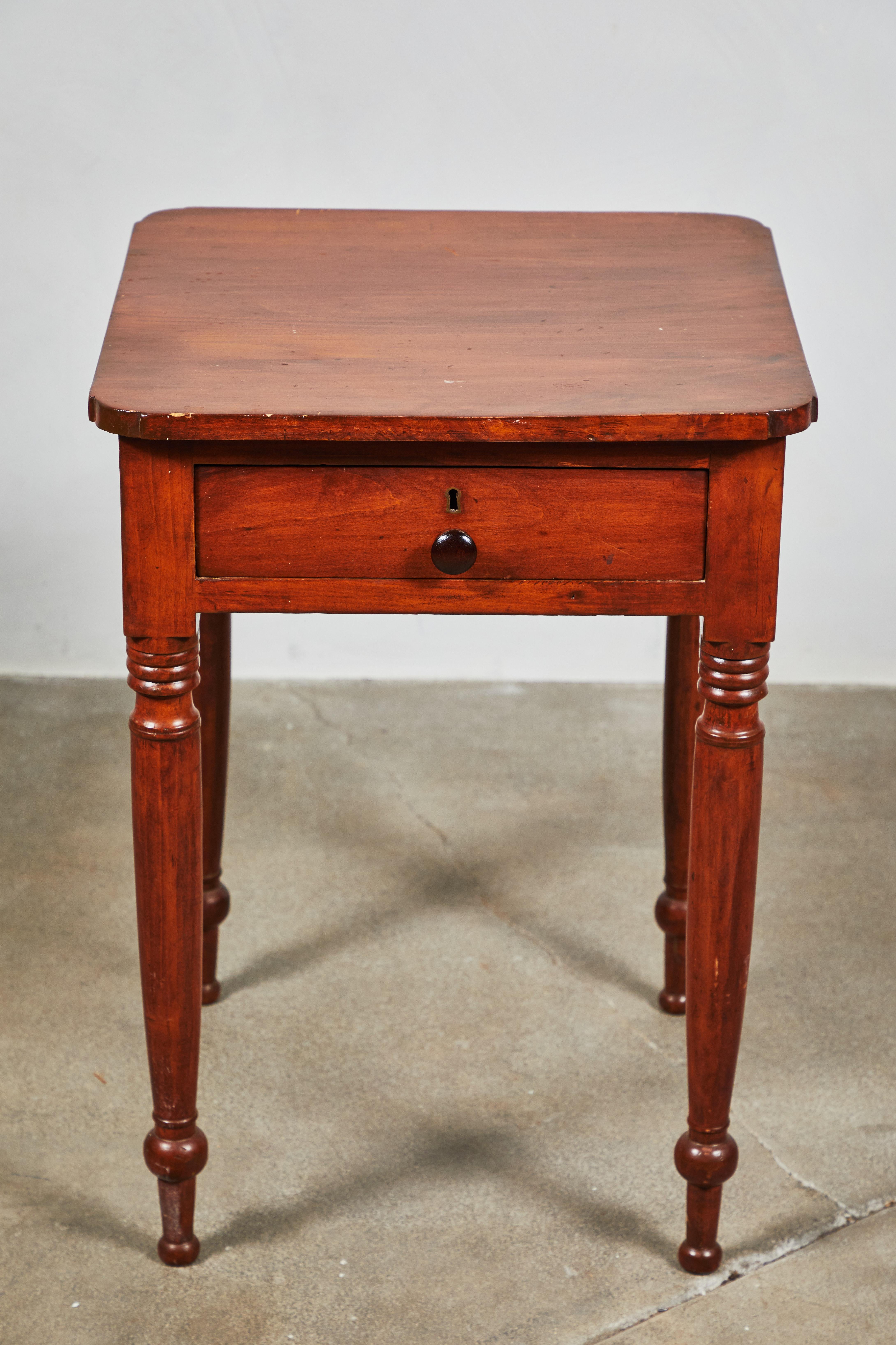 Early American side table with drawer and turned legs. Original finish cheery wood finish.