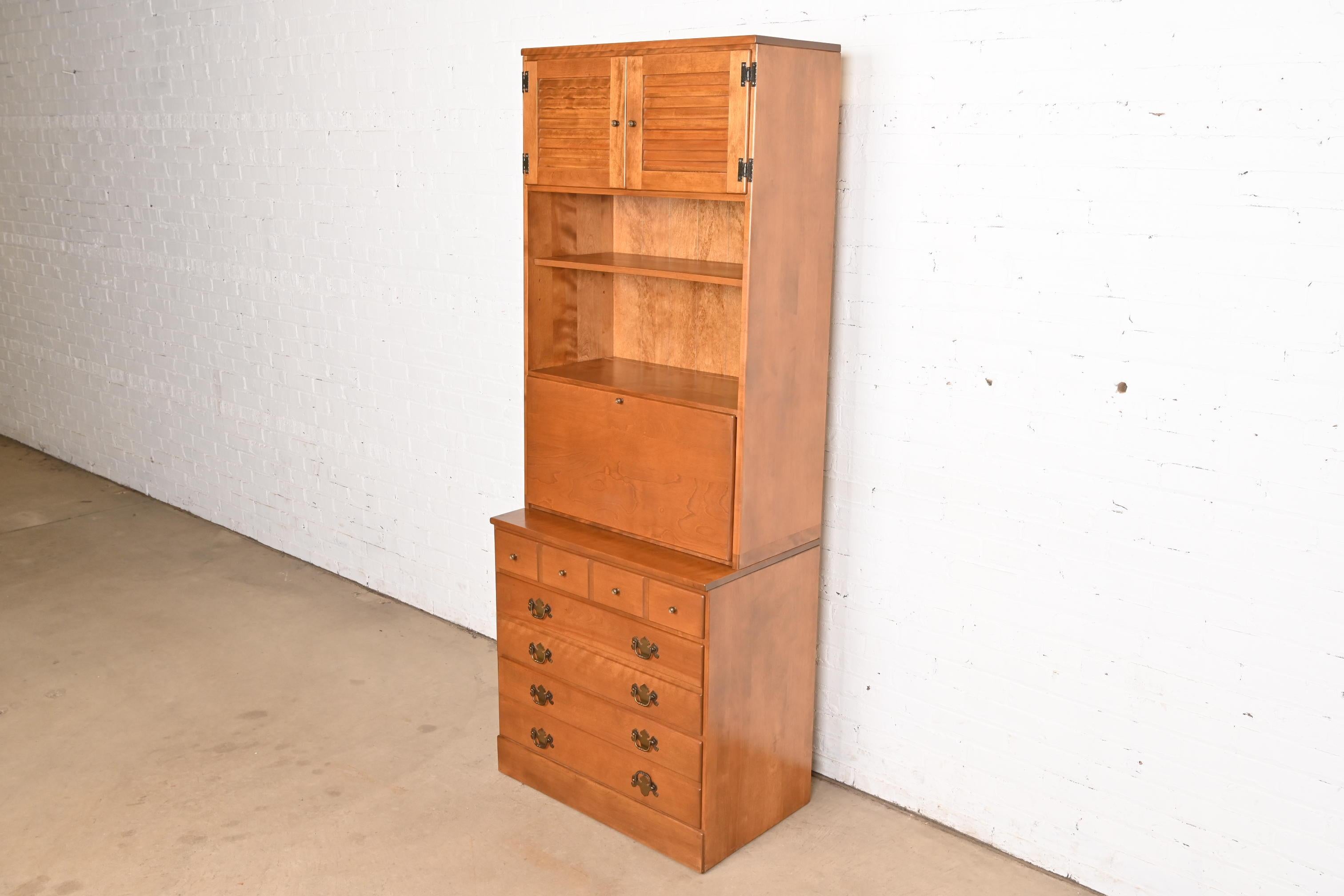 A beautiful American Colonial or Chippendale style bureau with drop front secretary desk and bookcase hutch top

USA, Circa 1970s

Gorgeous carved solid maple and birch, with original brass hardware.

Measures: 30.25