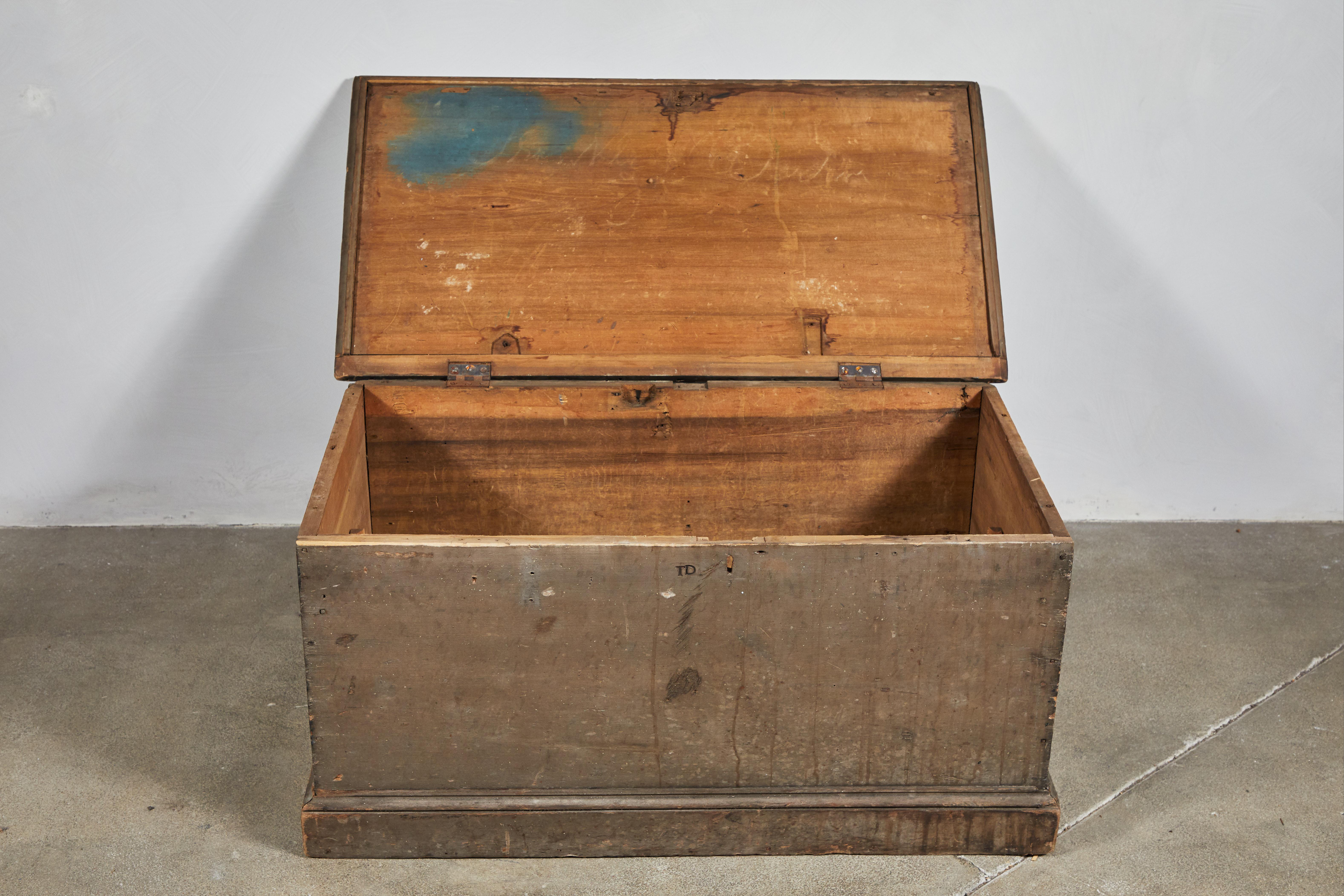 Early American storage trunk with original stained finish.