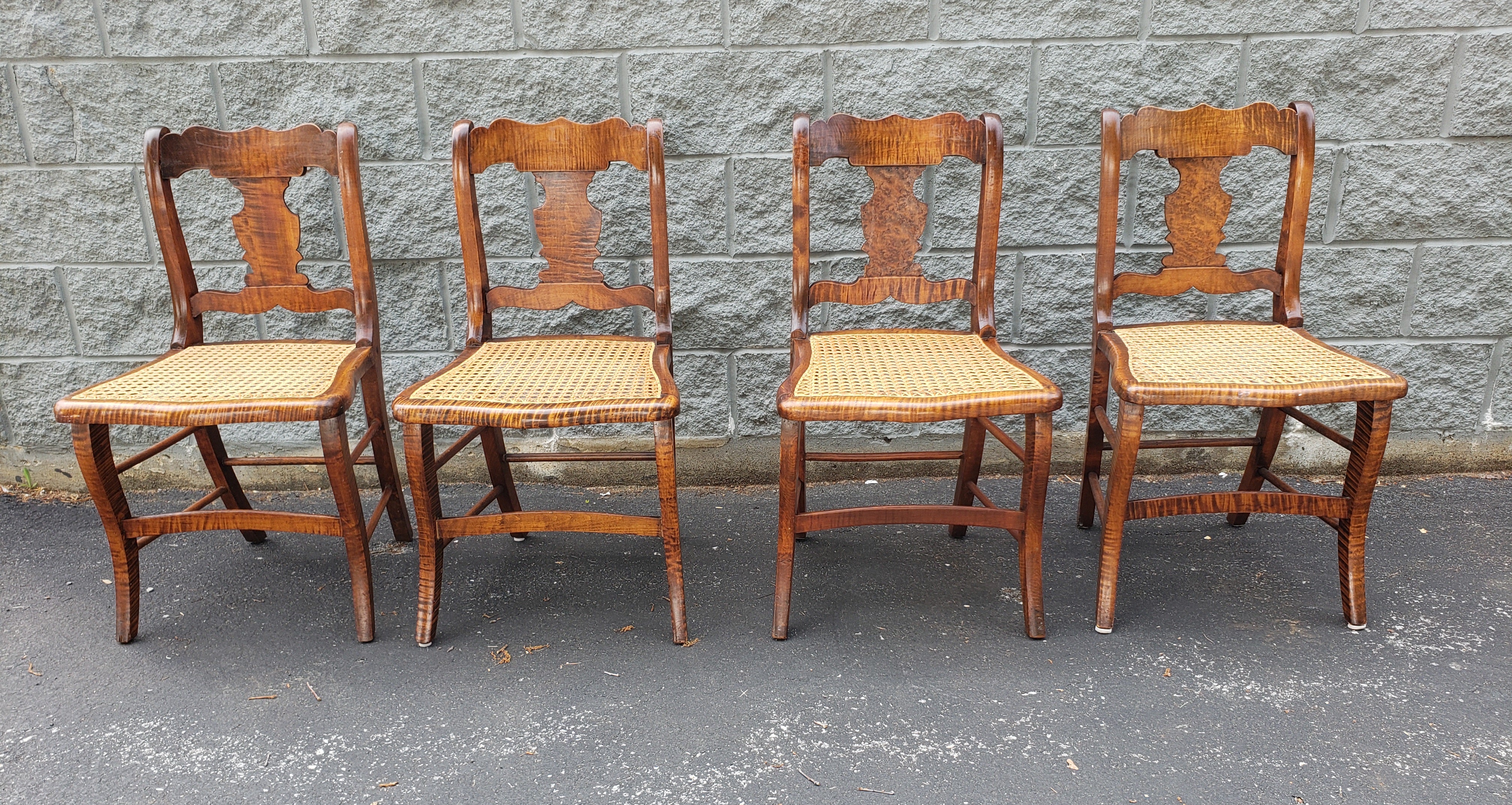Beautiful set of 4 early American style side chairs in tiger wood and newly reacned seats. Chair have been recently refinished and recaned. Measures 17.5