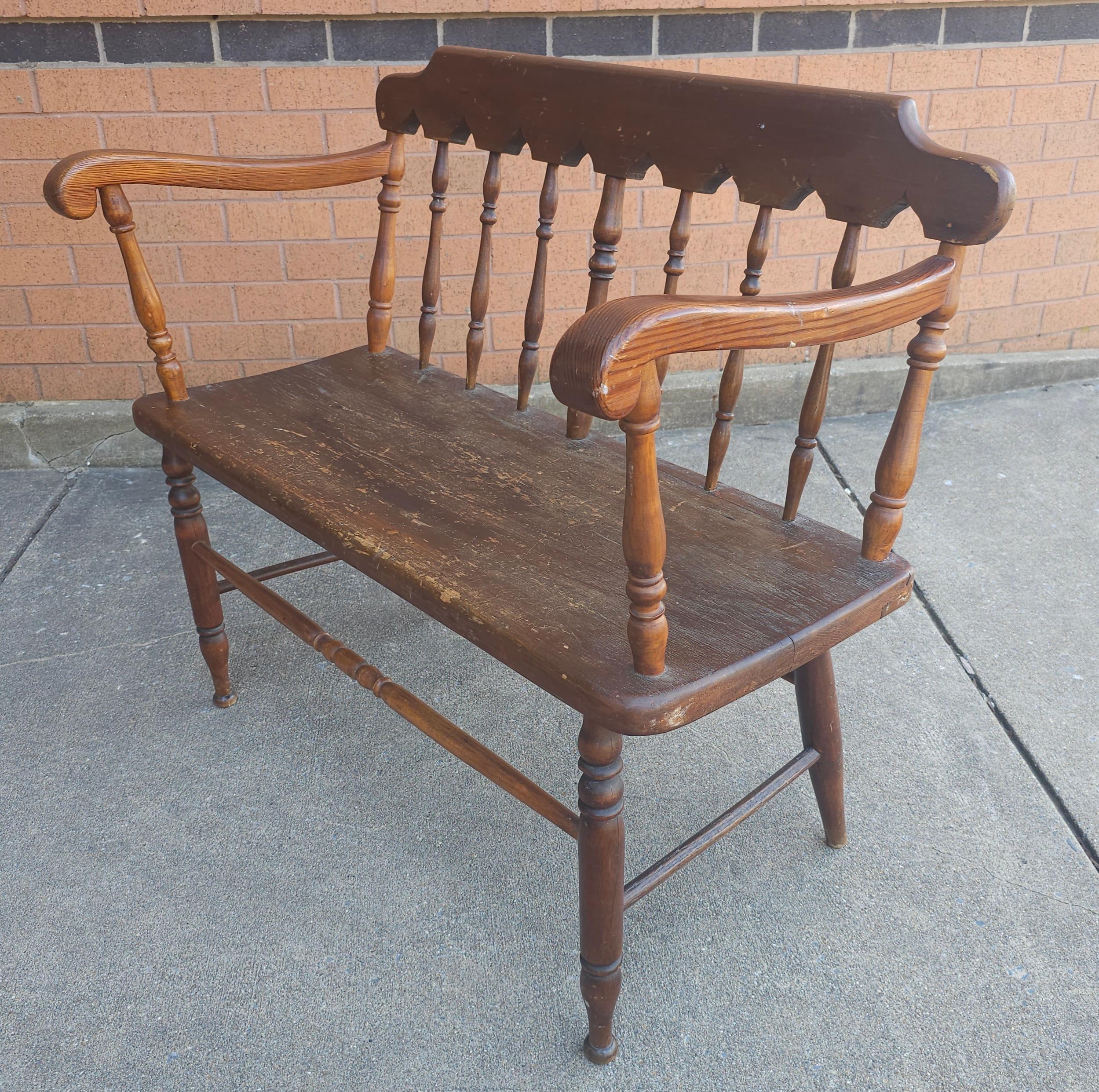 An Early American Style two seater bench measuring 36.5