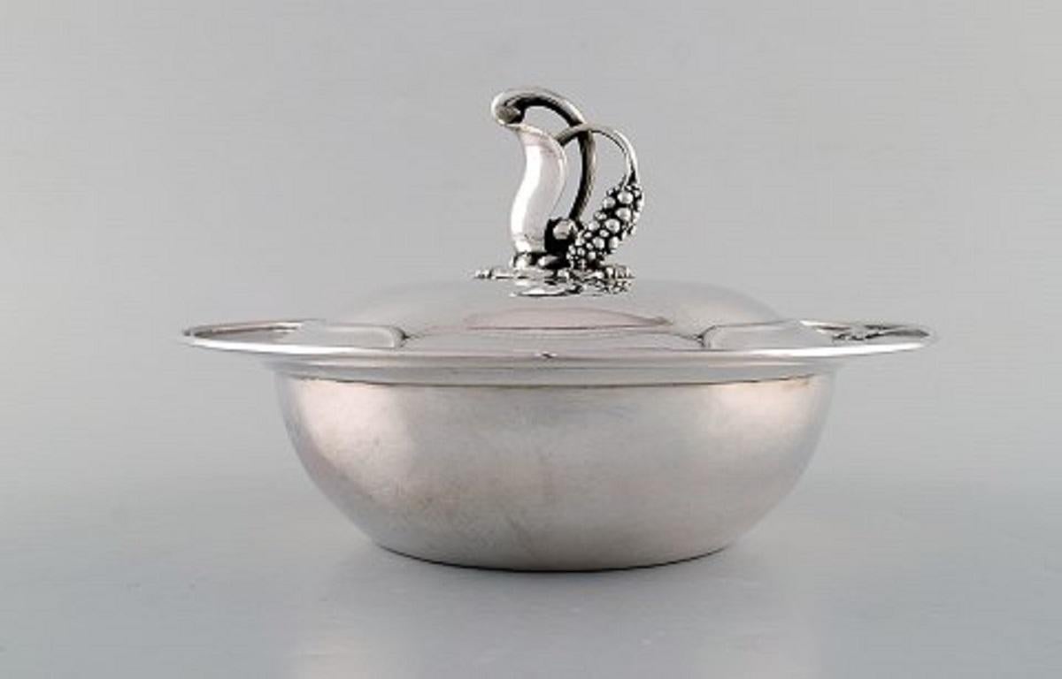 Early and rare Art Nouveau Georg Jensen lidded bowl in hammered silver. Knob in the form of foliage. Model number 228. Designed by Georg Jensen. Dated 1915-1930.
Measures: 23 x 15 cm.
In very good condition.
Stamped.
With Swedish import stamps.