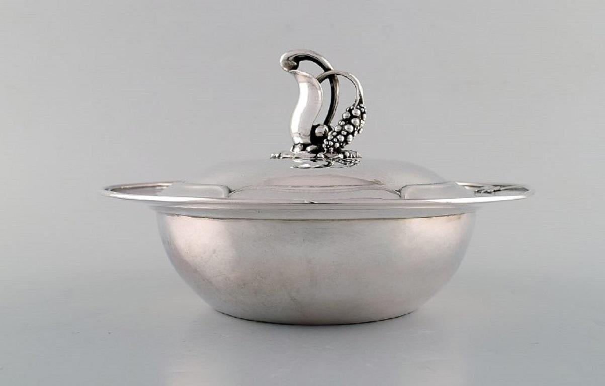 Early and rare Art Nouveau Georg Jensen lidded bowl in hammered silver. 
Knob in the form of foliage. Model Number 228. 
Designed by Georg Jensen. 
Dated 1915-30.
Measures: 23 x 15 cm.
In very good condition.
Stamped.
With Swedish import