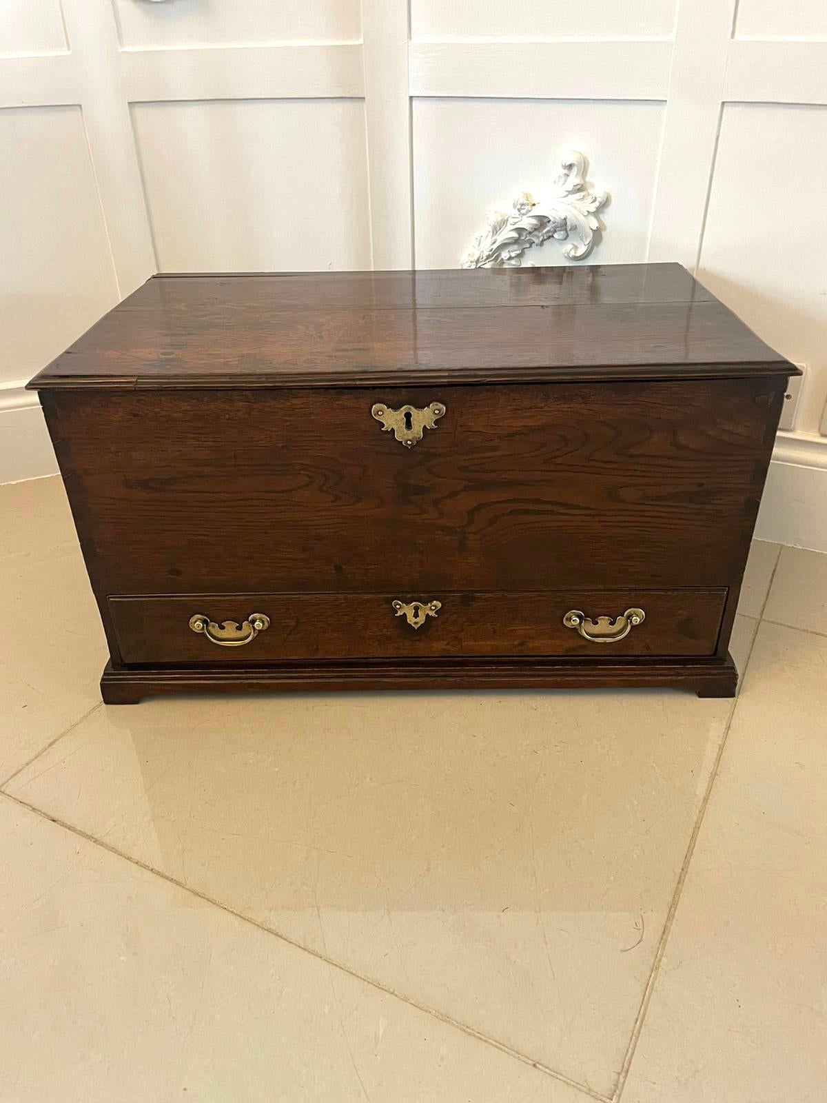 Early Antique 18th century small Welsh oak coffer having a quality oak removable lid with a moulded edge revealing a storage compartment, one long drawer, quality brass handles and escutcheons standing on bracket feet. 

A very desirable example