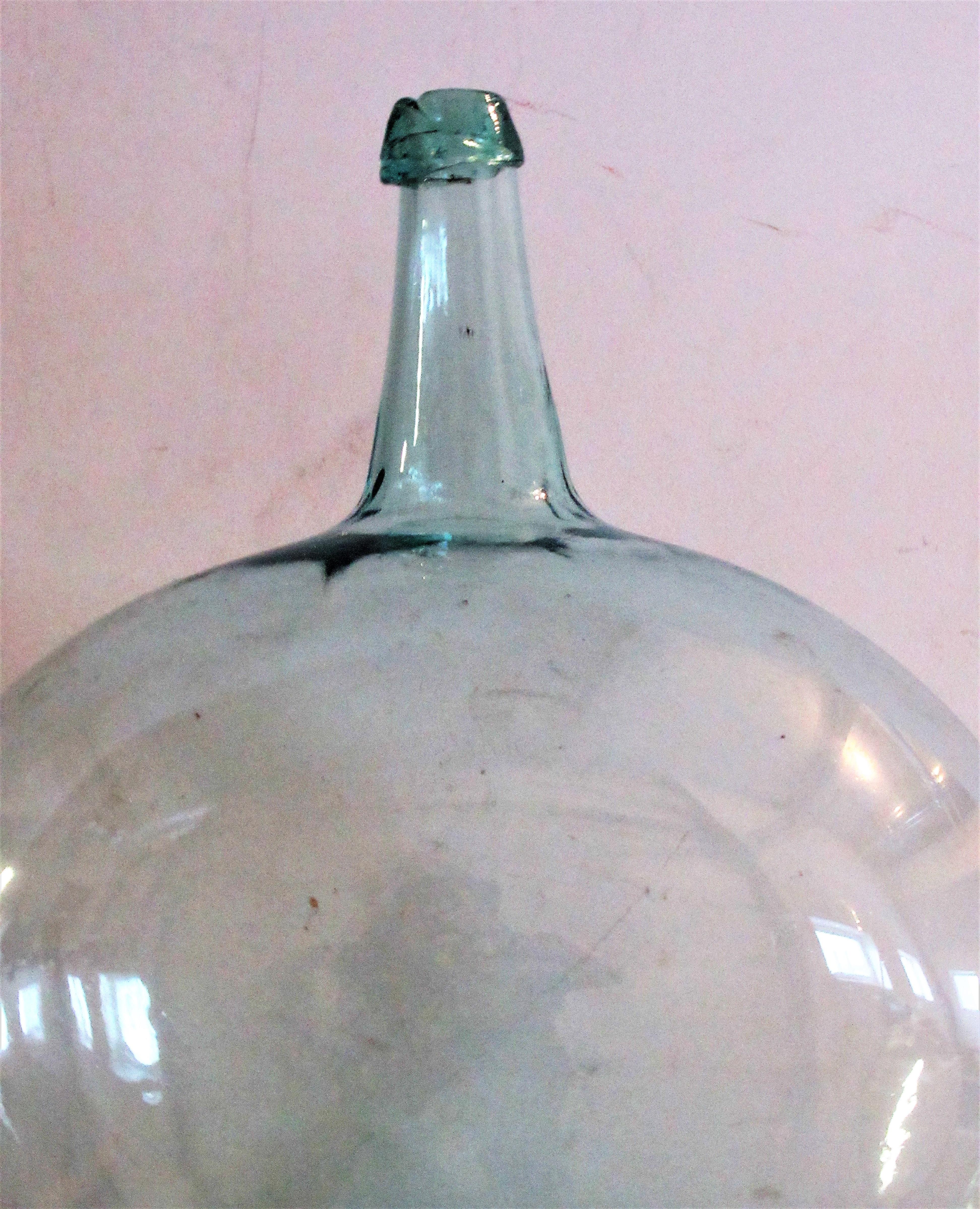 Early antique pale aqua blown glass demijohn bottle with a bold exaggerated sculptural bulbous form and a very deep dished pontil. From an old private collection -most likely Western New York State in origin dating anywhere from the late 18th