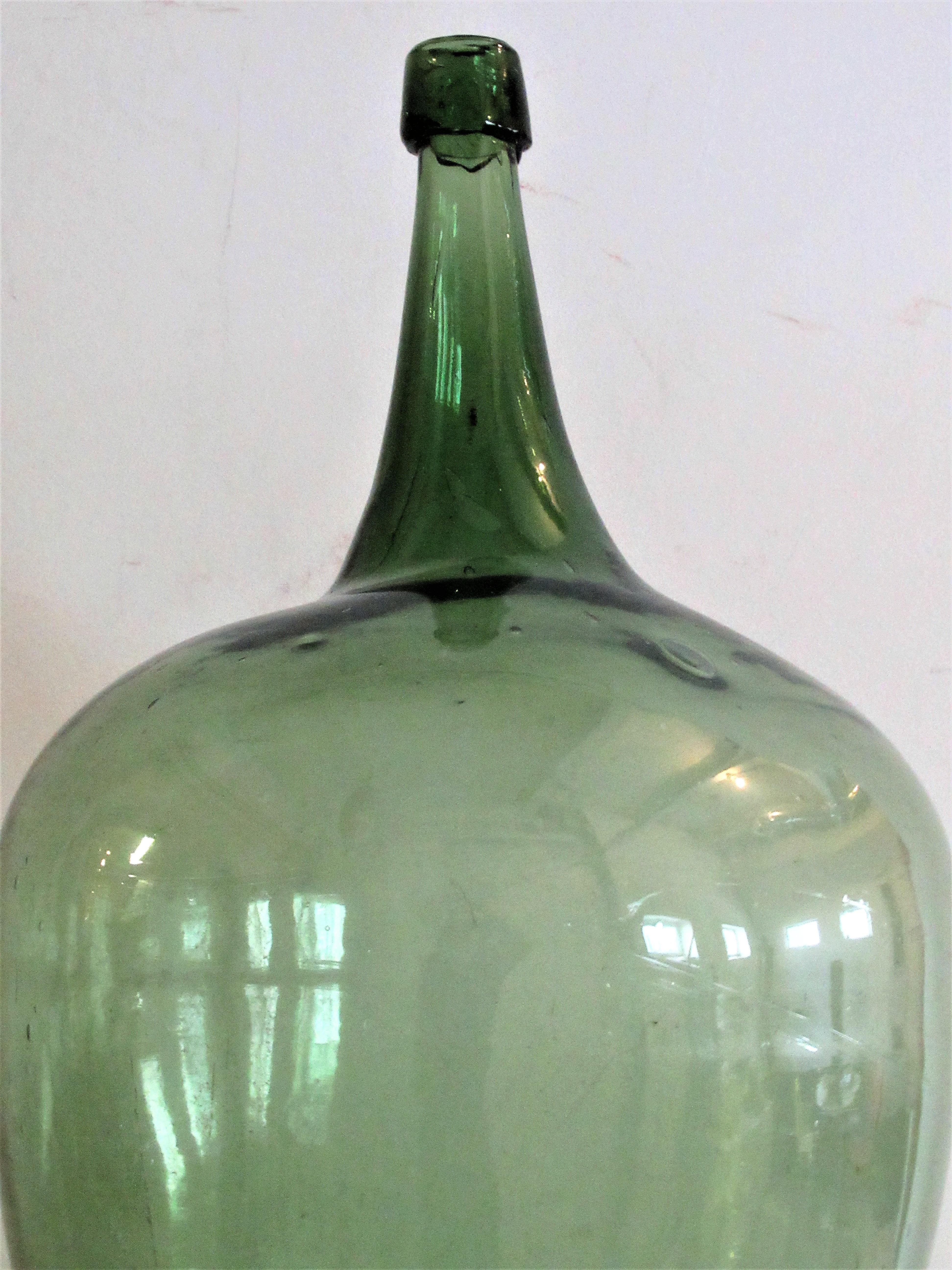 Early antique American blown green glass demijohn with a beautiful bold irregular sculptural form and a very deep dished pontil. From an old private collection - most likely Western New York State in origin dating anywhere from the late 18th-early