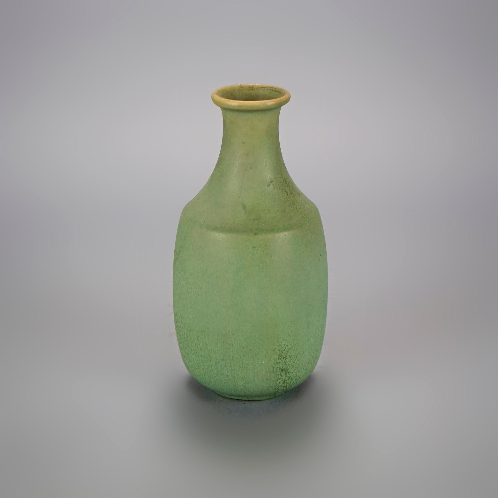 An early antique Arts and Crafts vase by Van Briggle offers art pottery construction in stylized bottle form, maker signed on base as photographed, c1910

Measures- 8.5''H x 4.25''W x 4.25''D