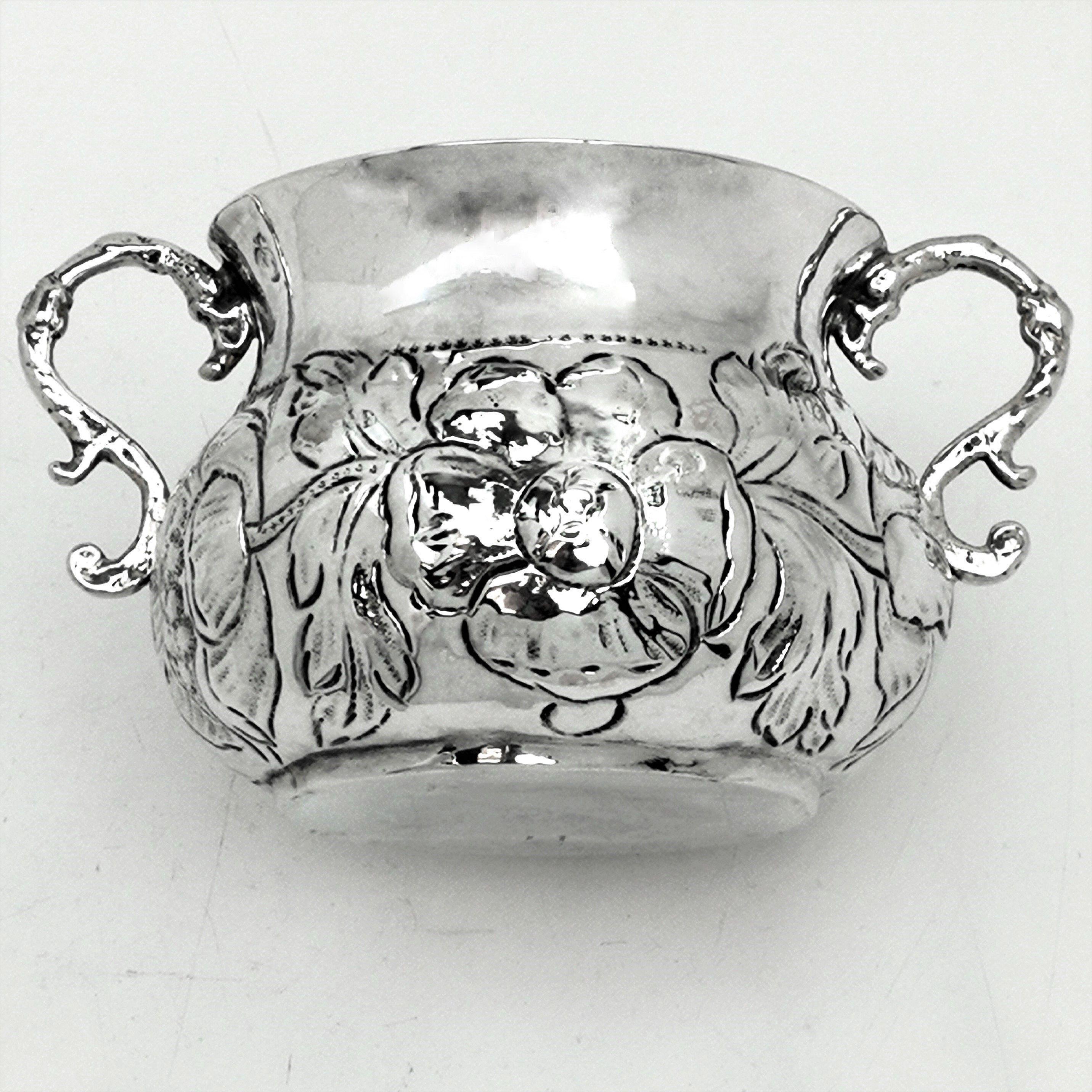 A wonderful 17th century Charles II Antique solid Silver Porringer / two handled Cup with an ornate chased floral design around the bellied body of the Cup. The Cup has two elegant scroll handles.

Made c.1675 by maker TA (Makers Mark in Jackson's
