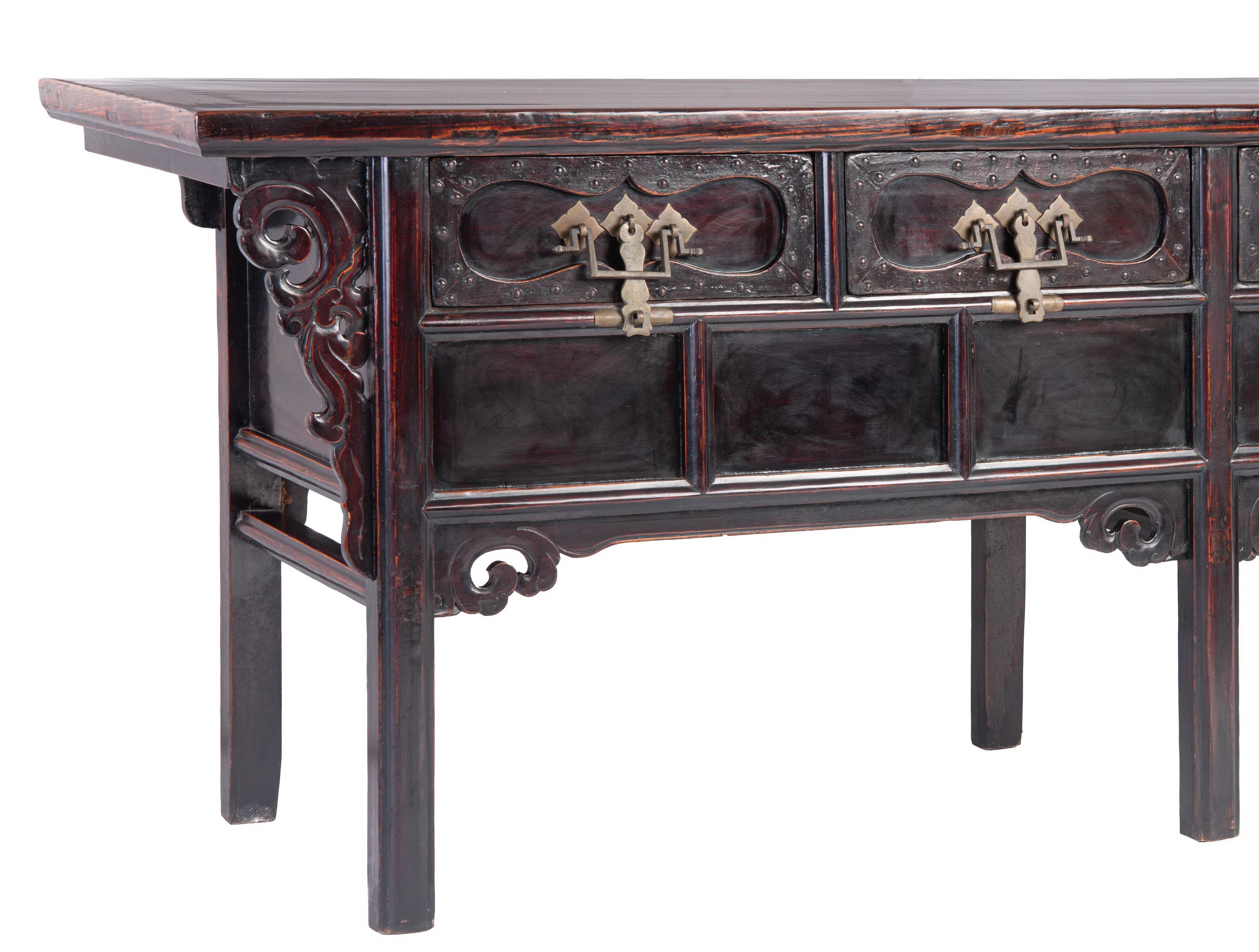 The superb raised coffer featuring a floating top panel inset within an ice-plate edged frame, protruding over open-carved scrolled foliage spandrels, a row of four drawers carved with shaped cartouches, decorated with brass studs and fitted with