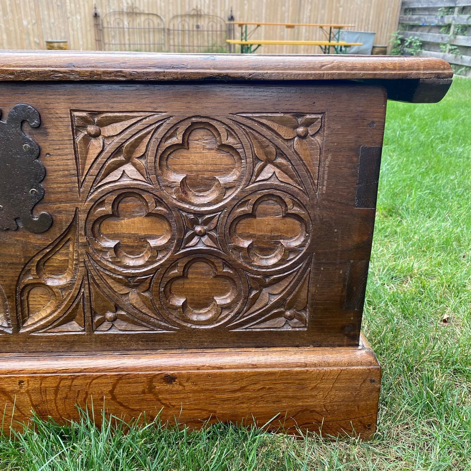 French oak Jacobean style hinged coffer with molded plank edge top, stunning decoratively carved front panel consisting of lovely gothic motif or replicating stained glass windows. With original inset hinged lid. Nice medium size. 
#6042.



