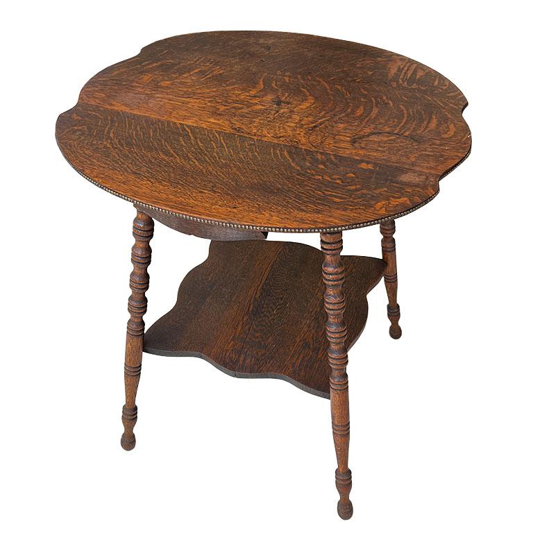 A very old early American antique parlor table created from Tiger Oak. This side table is an excellent example of early American-style classical furniture. The estate that it was sourced from belonged to a ranching family and had been passed down