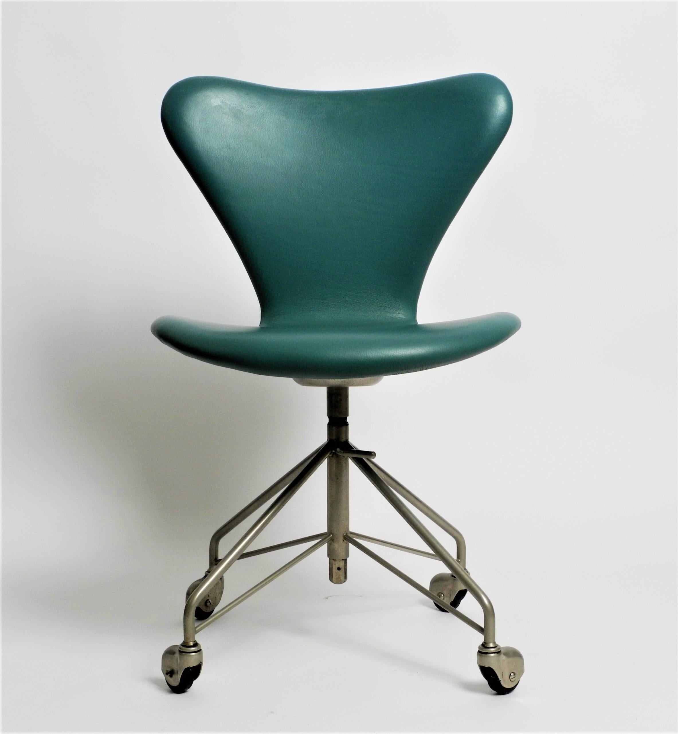 Early Mid-Century Modern office chair model 3117 with the rare four rolls base and adjustable height. Designed by Arne Jacobsen for Fritz Hansen. Produced arround 1960.

Executed in turquoise vinyl and chrome-plated steel.

Dimensions:
H 30.7 -