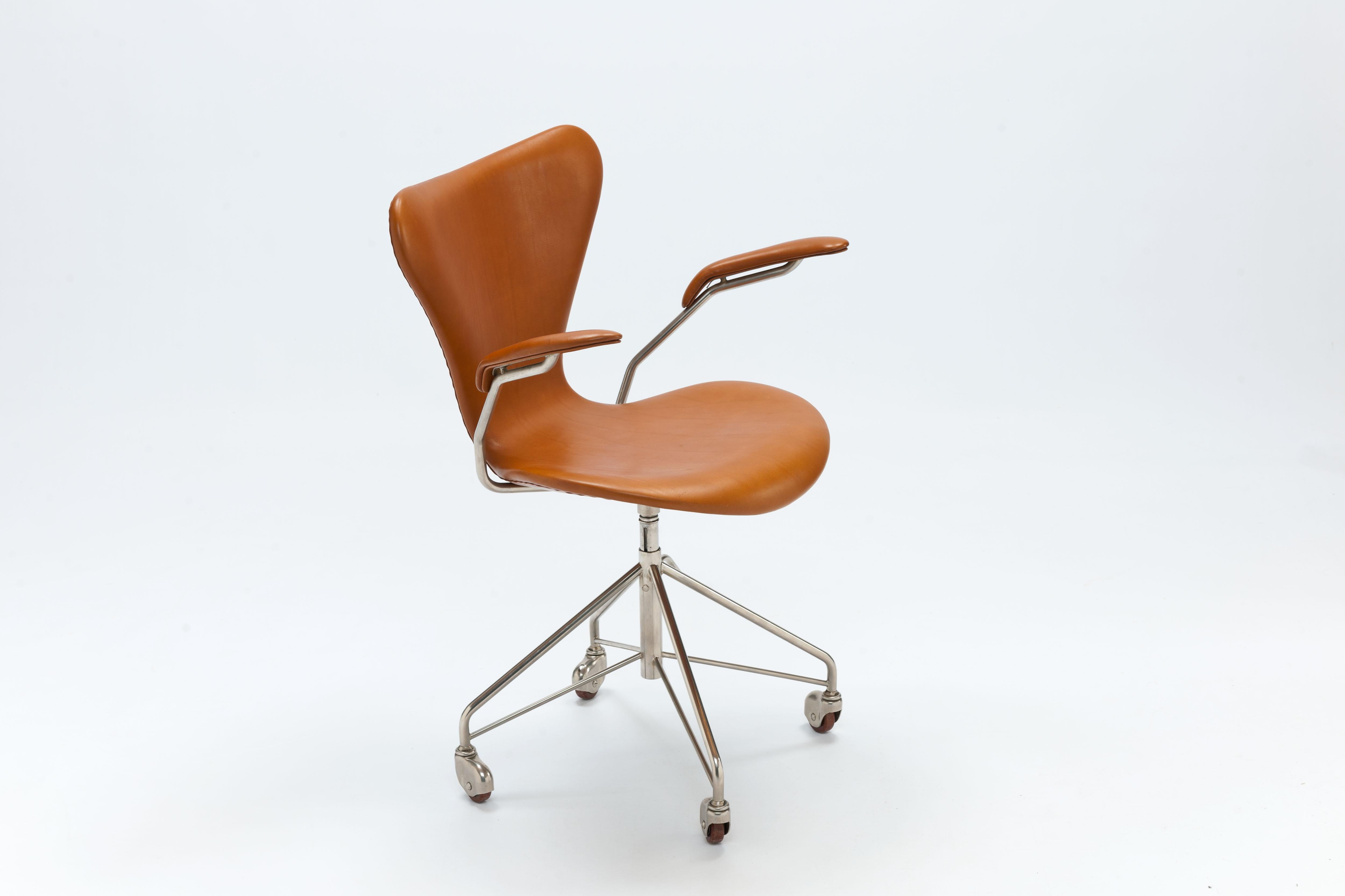 Arne Jacobsen swivel desk chair model 3217 office chair with armrests. Original, nickel finish first series four-star swivel base on casters. Designed by Arne Jacobsen in 1955.
This chair dates back to the first years of production indicated by the