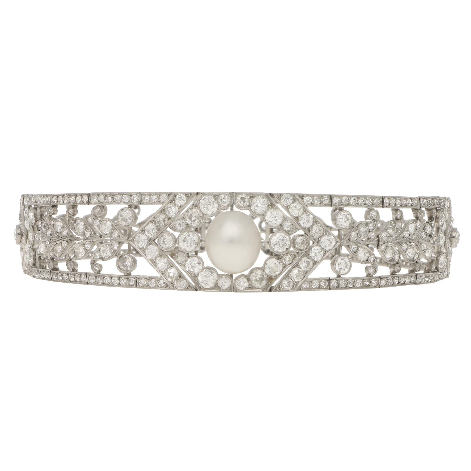 A truly spectacular antique diamond and pearl convertible diadem/choker, set in platinum. Circa 1915-1920

This piece is a true one of a kind and centrally features a beautiful 12 x 11 millimetre natural white pearl. This large pearl is perfectly