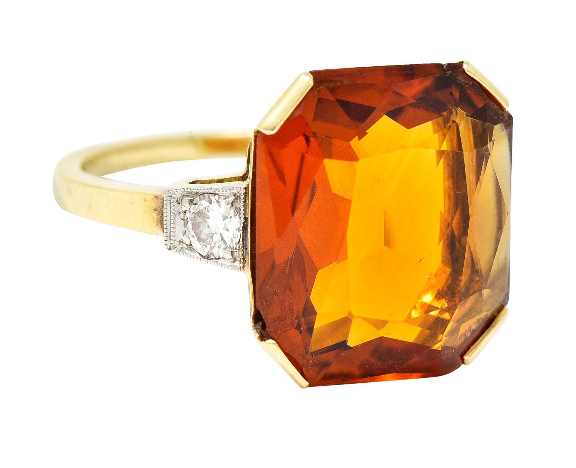 Ring centers a cushion cut citrine measuring approximately 13.0 x 14.0 mm

Transparent and deeply saturated orange 

With minor conchoidal fracture concealed by wide prongs

Flanked by two old European cut diamonds bead set in platinum

Weighing