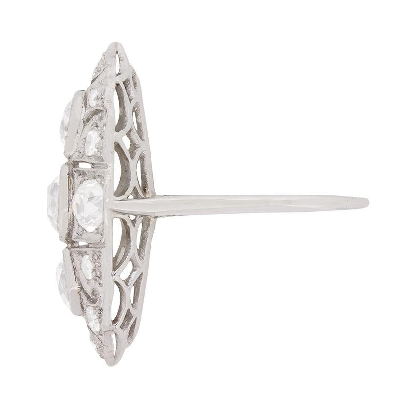 A unique and stunning style, this cluster ring falls within the 'boat' description of antique jewellery. It's almost marquise shaped body, and deep gallery, gives the ring a chunky body, closely relating to a boat, hence the name! It features three