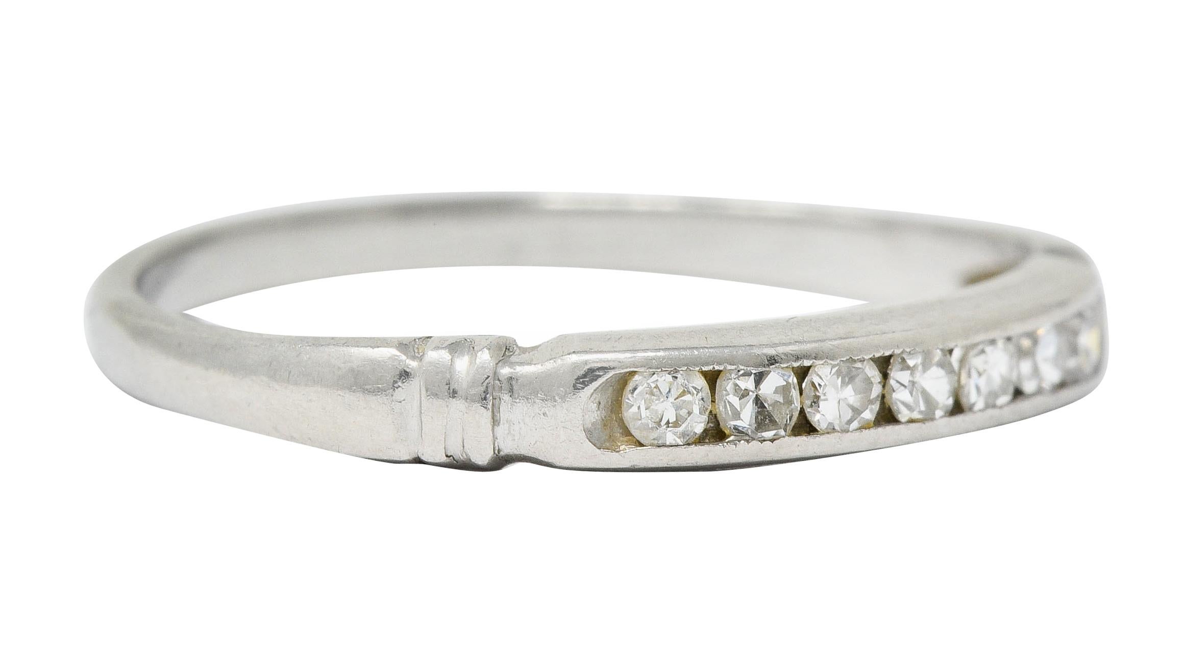 Thin band ring with ribbed shoulders and channel set to front

With seven single cut diamonds weighing in total approximately 0.15 carat; eye-clean and white

Tested as platinum

Circa: 1920s

Ring Size: 6 & sizable

Measures: 2.6 mm wide and sits
