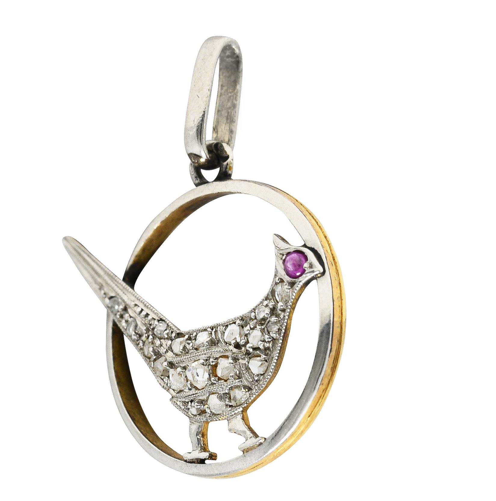 Designed as a perched bird within a circular frame. Bead set throughout with rose cut diamonds.
Weighing approximately 0.30 carat total. Quality consistent with cut and age. Accented by a ruby cabochon eye. Transparent bright purplish-red. Tested as