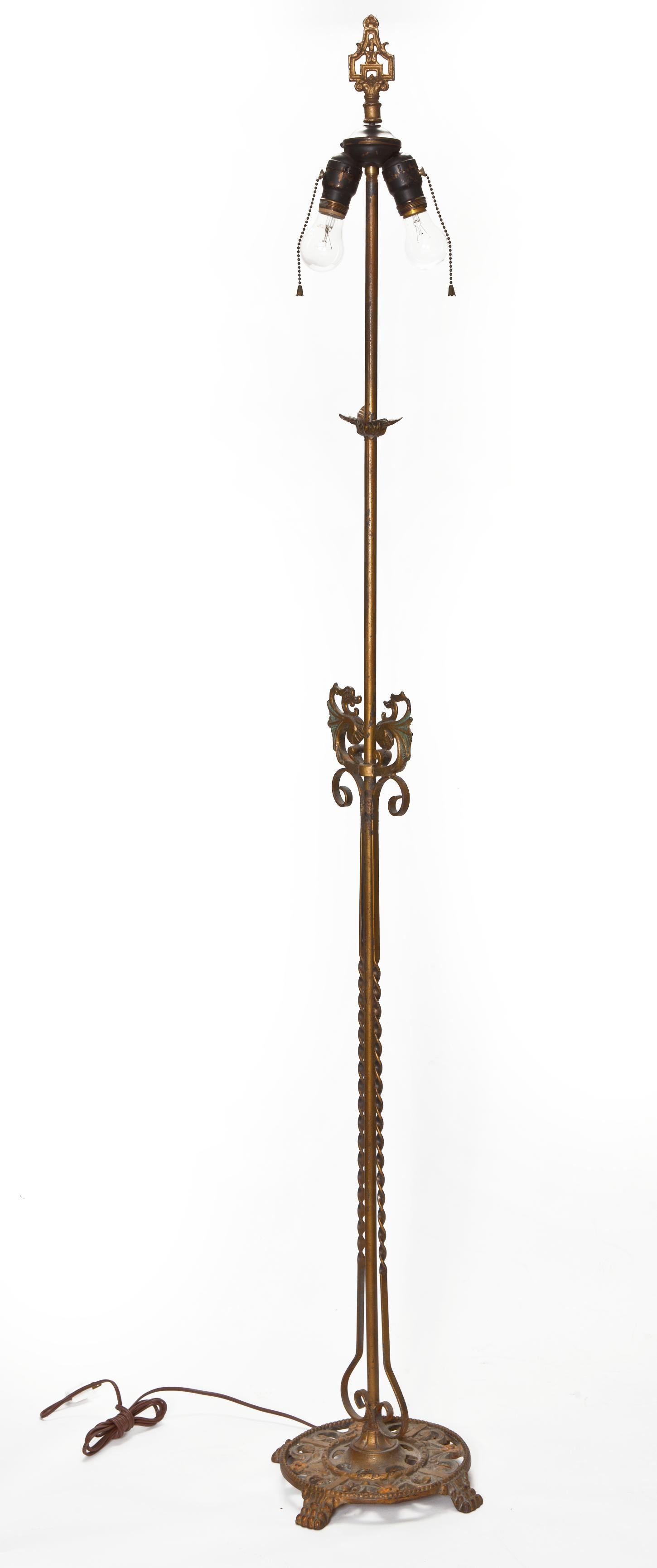 Classic 1920’s wrought iron floor lamp. All original surfaces. Re-wired solid brass sockets, standard bulbs recommended. Lamp has pull chain for two directional sockets. New classic burlap shade is included. 
Measures: Shade is 11