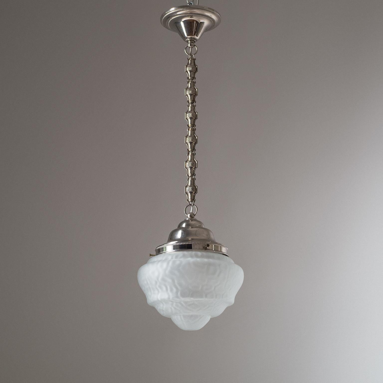 Magnificent Art Deco pendant from the early days of the 20th century. A very rare satin glass diffuser with a softly tiered silhouette and a unique animal skin-like texture is suspended by nikeled brass hardware. Beautiful original condition with a