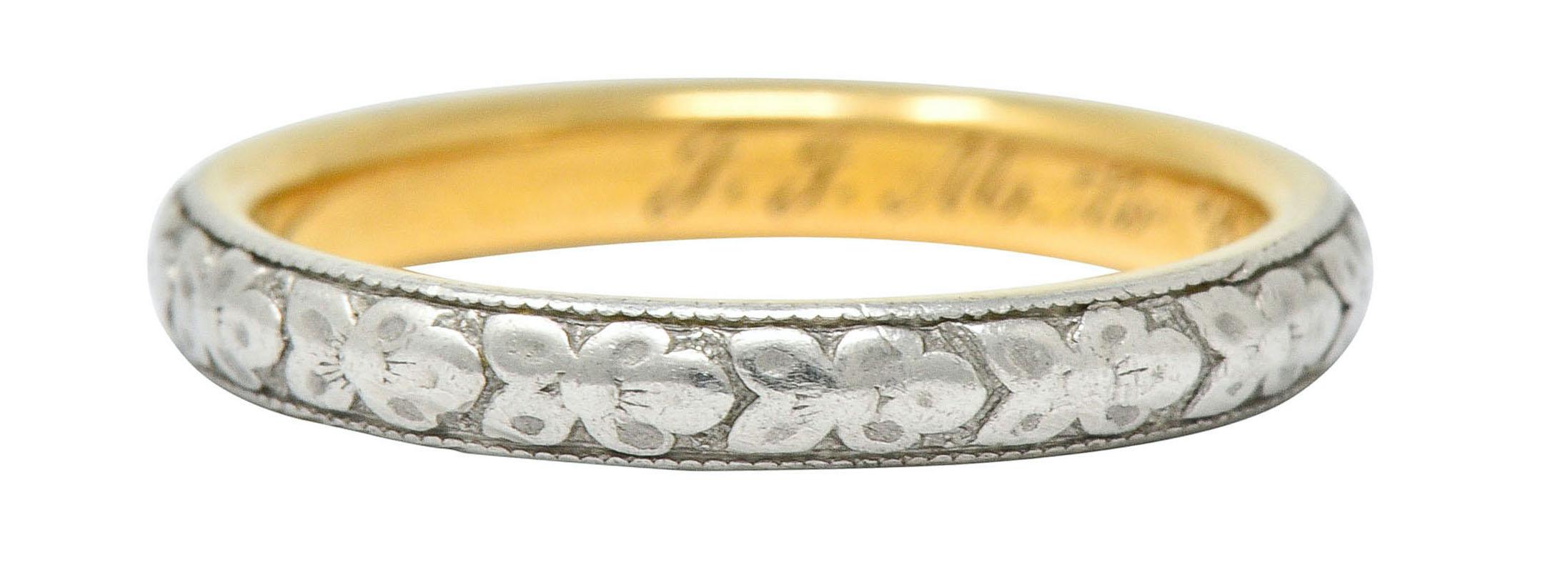 Band ring features a highly rendered platinum floral motif, fully around

Inner shank is yellow gold with a dated inscription

Stamped 18K for 18 karat gold and tested as platinum-topped

Circa: 1920s

Ring Size: 4 1/2 & not sizable

Measures: 2.5