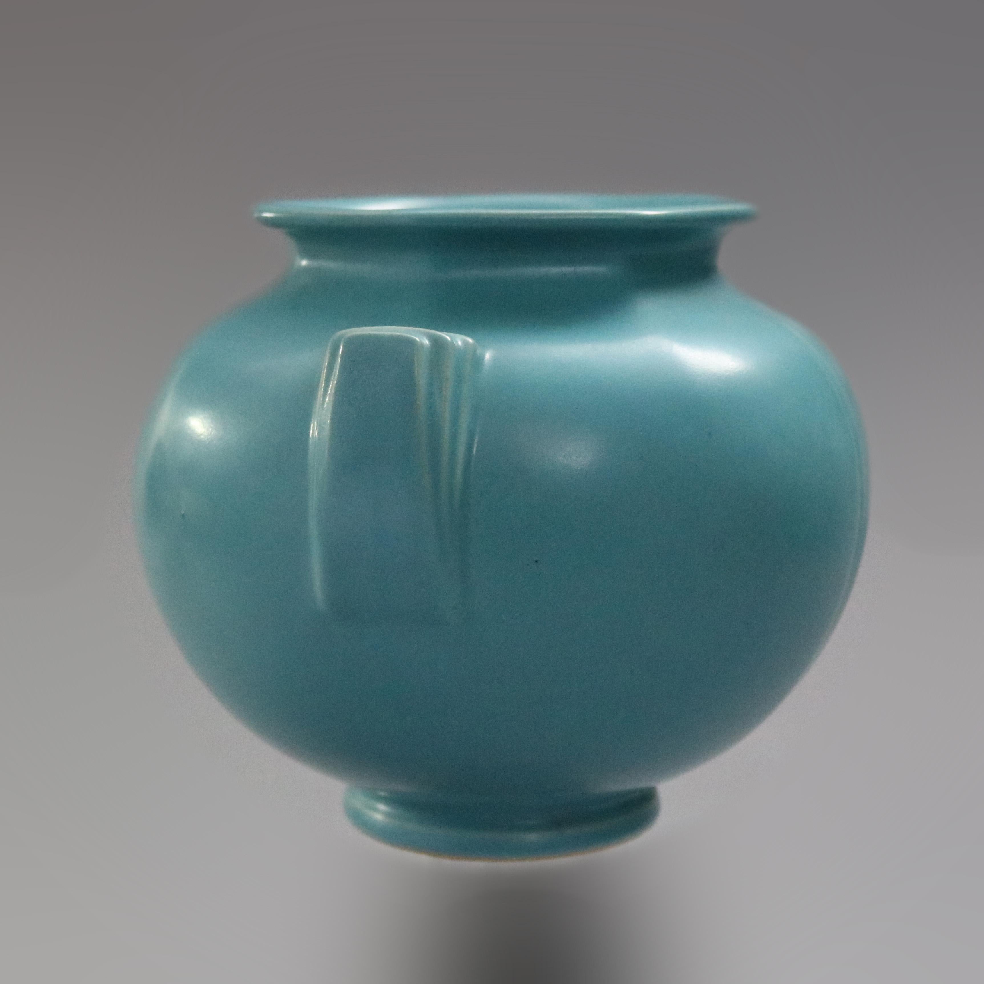 An early Art Deco vase by Roseville offers art pottery construction of faceted, double handled and footed vessel in matte glaze finish, base label reads 