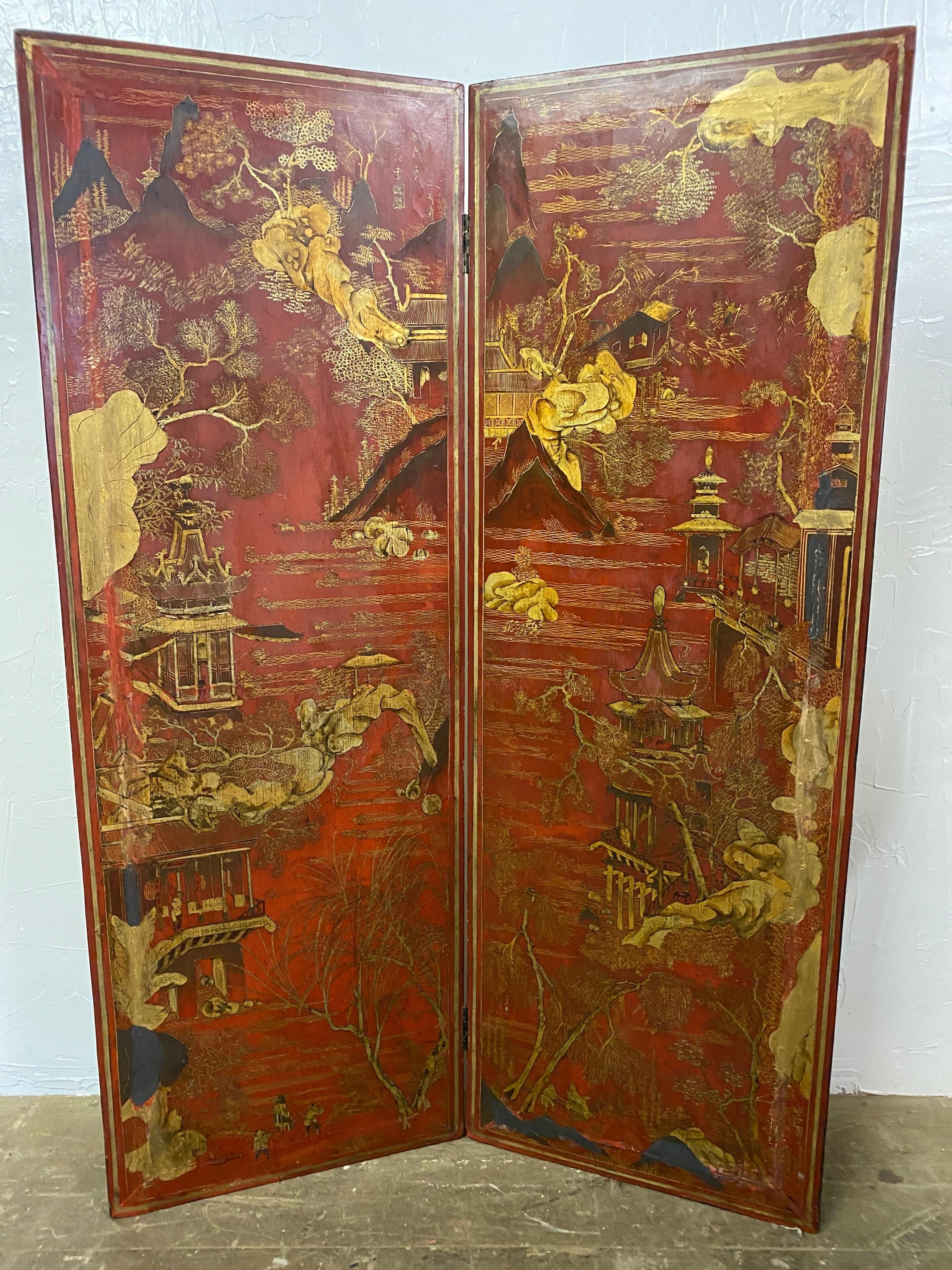 A beautifully enamel painted early Asian two part wooden folding screen, each section measuring 19.5
