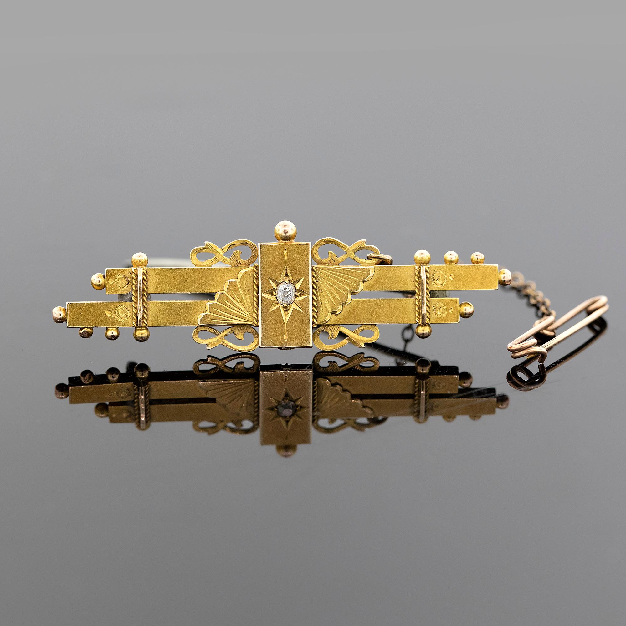 Early Australian double-bar brooch with scrolled wire-work and granulation set with one old cut diamond on raised star engraved rectangle, with fans either side. Complete with safety chain. Hallmarked with an early Australian maker mark