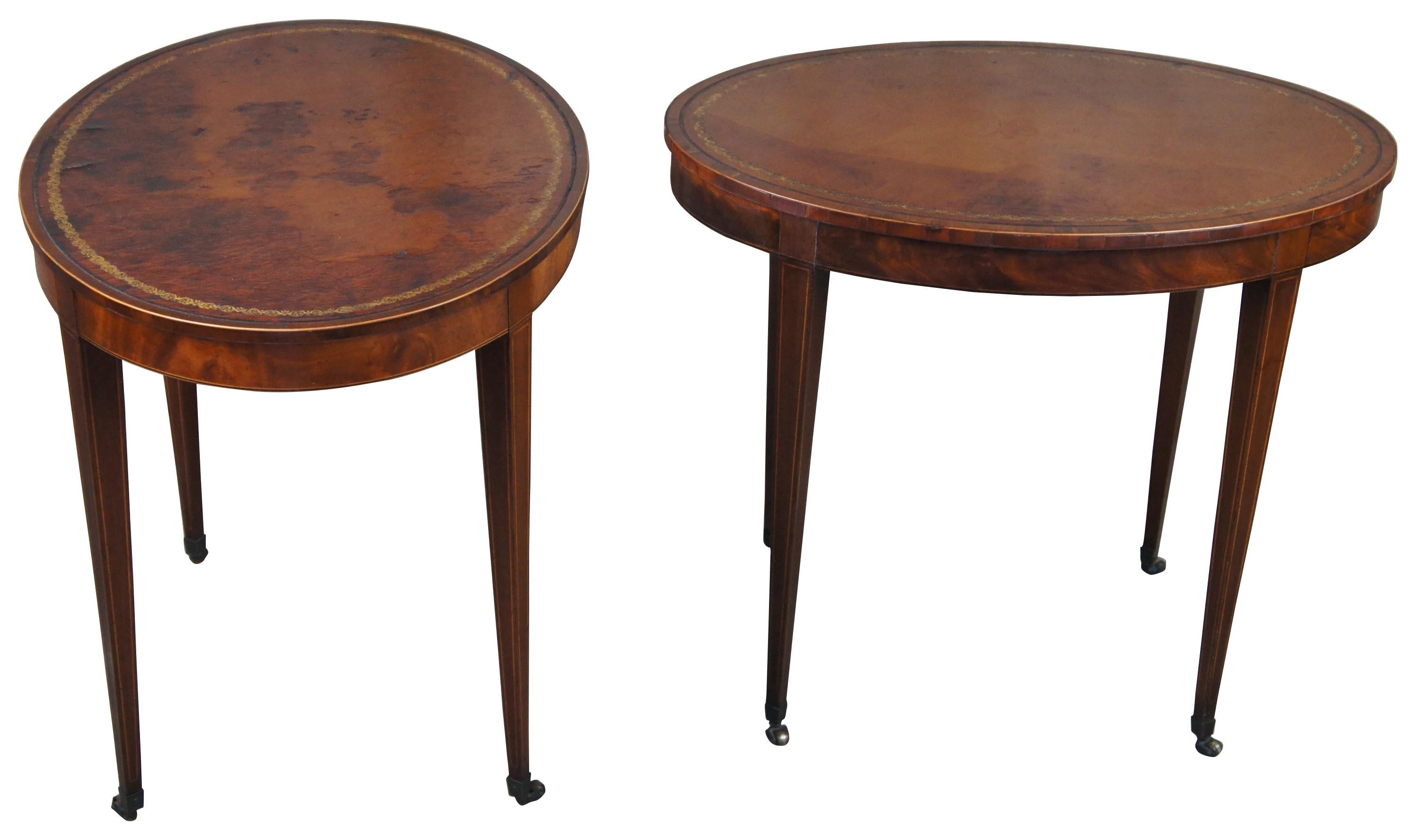 Early Baker Furniture oval side tables, circa 1940s.  Made from flame mahogany with tooled leather tops.  Features inlay and square tapered legs leading to castors.  Drawing inspiration from Sheraton and Hepplewhite styling.

Table 1 - 30