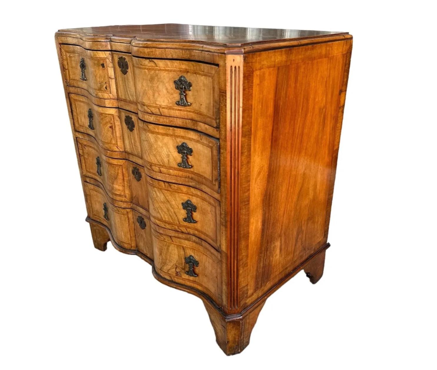 19th Century Italian early banded walnut inlay serpentine front chest. Chest has four drawers, each with original brass hardware supported by bracket feet. Wonderful old mellow patina to the walnut.