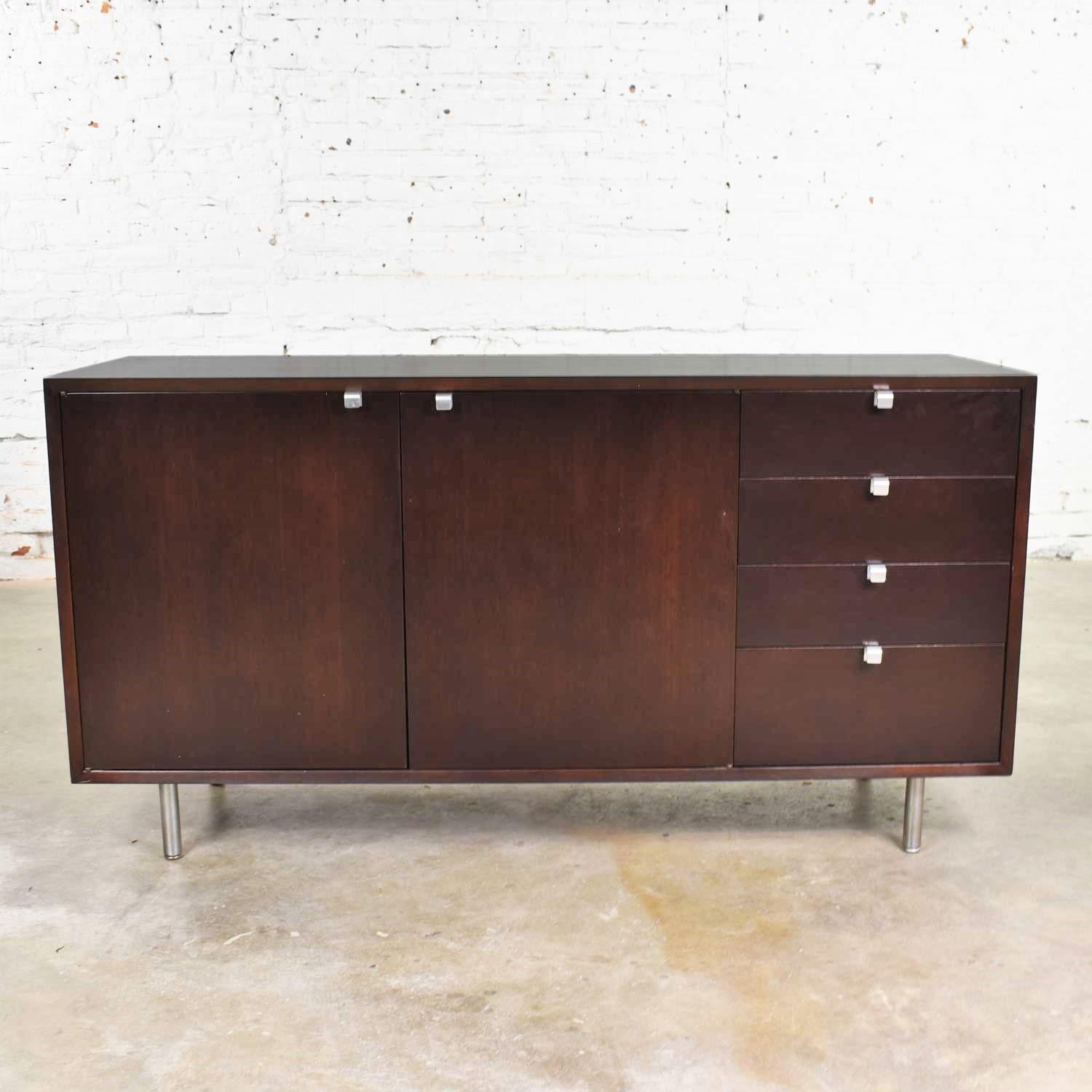 Handsome BCS Basic Cabinet Series sideboard or credenza in walnut designed by George Nelson for Herman Miller. This cabinet is in fabulous condition. It was restored prior to us acquiring and has been used a little since; so, there are some small