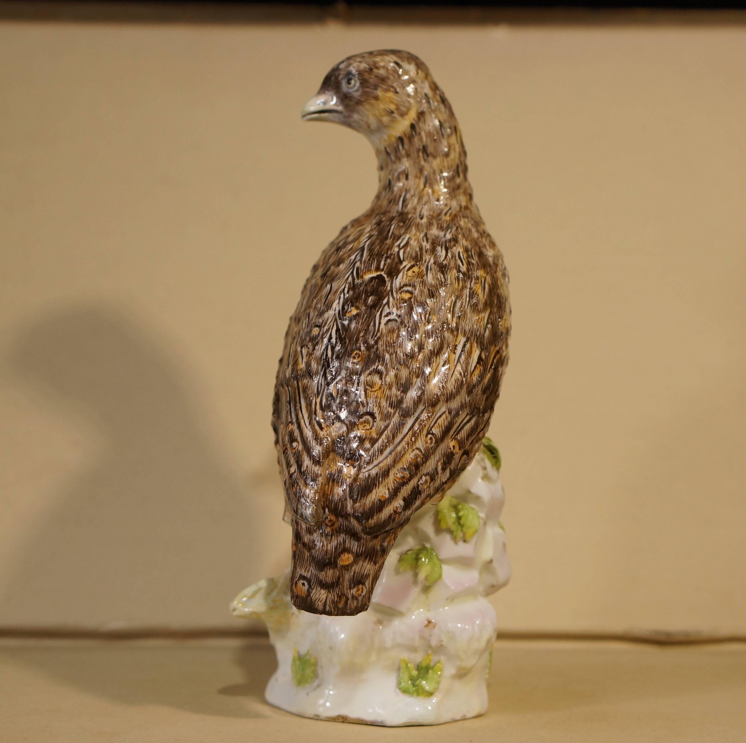 Rare early Wegely (Berlin) figure of a partridge, modelled standing on a rocky plinth with scattered leaves and a corn of wheat, the bird beautifully painted with mottled brown feathers including 'eyes'. 
Incised numbers '3.1.' 
circa