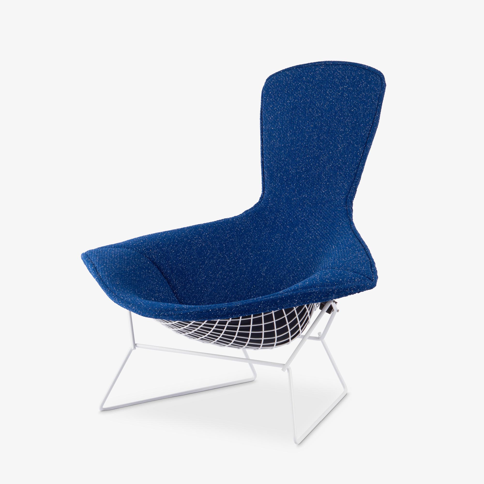 At a Glance:
- An early example of Bertoia’s Bird Chair design, fully restored.
- The newly crafted upholstered cover features a Raf Simons designed wool bouclé by Kvadrat.
- The sleek Gloss White coated frame both preserves the chair and
