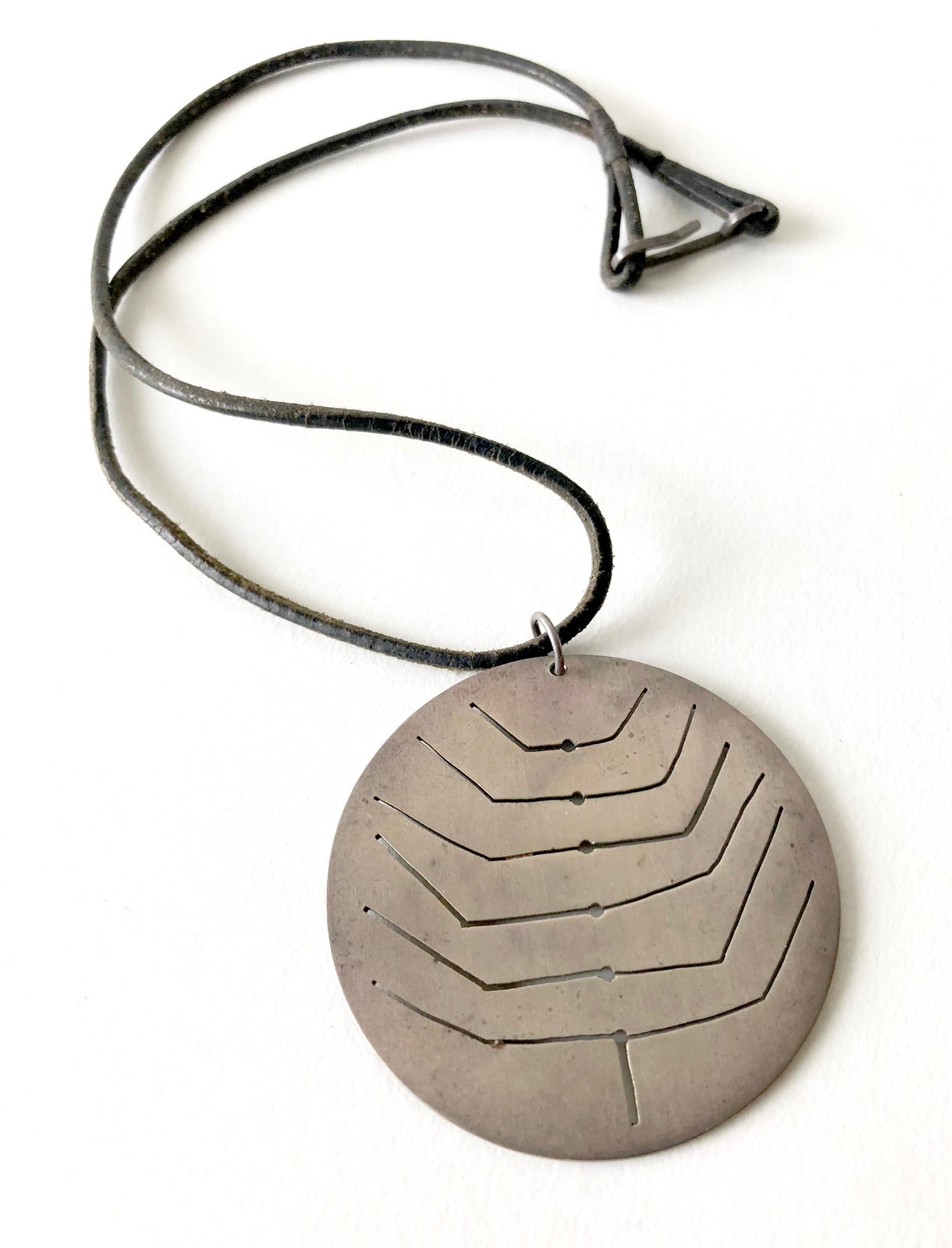 1950's sterling silver pendant with pierced abstract design created by Betty Cooke of Baltimore, Maryland.  Pendant has a 2