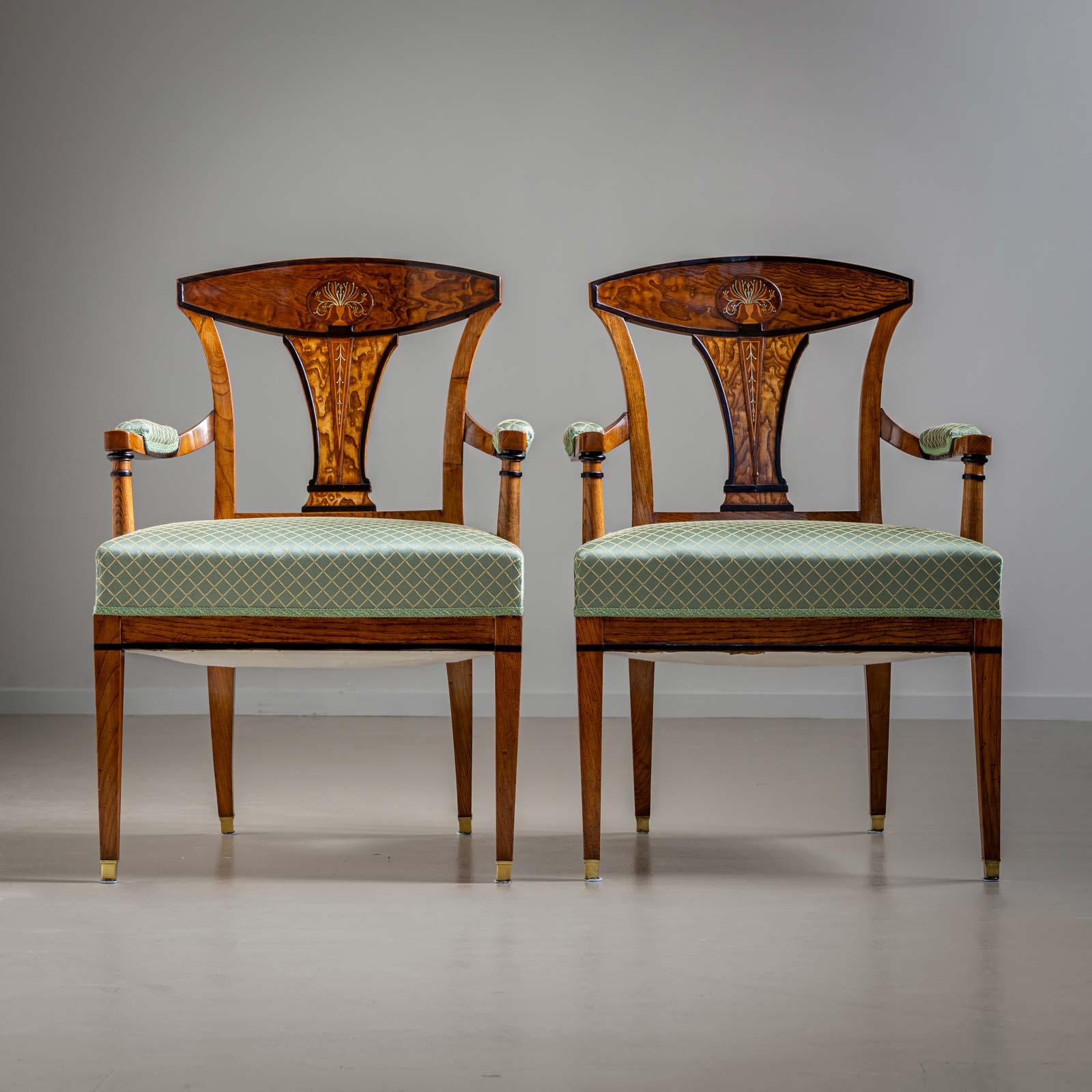 Elegant pair of Viennese armchairs, the outstanding quality of the Empire armchairs can be seen in the design of the backrest with floral bouquets and the finest brass inlays.