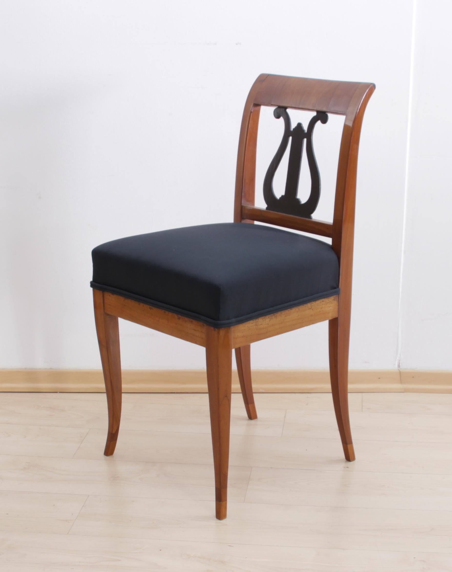 Wonderful, classic early Biedermeier chair from South Germany, circa 1820.

Beautiful ebonized back decor in form of a Lyra, a classic classicist and Biedermeier motif.
The wood is cherry solid wood and has been hand-polish with shellac.
For the