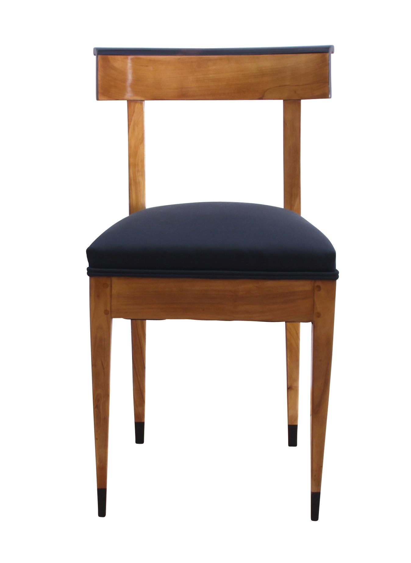 Very typical, Classic and plain Biedermeier from West Germany (Rheinland), circa 1820.
Bright cherry solid wood with ebonized parts. The curved backrest gives a very comfortable seat.

For the upholstery fabric a Classic black fabric with black