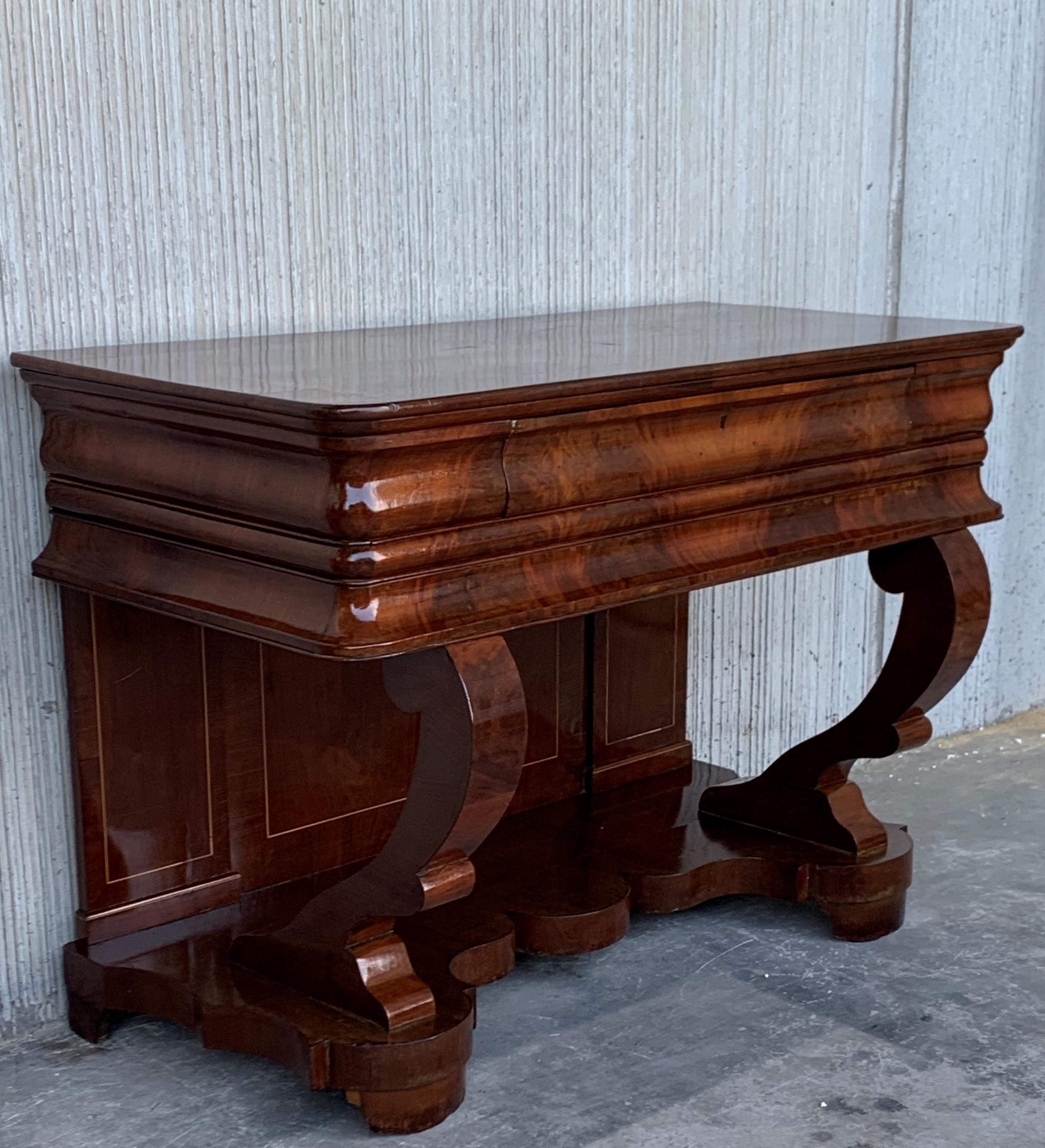 Absolute unique walnut wall console table artfully made in the early Biedermeier period circa 1830 in Austria. Made with finest walnut veneer, this rare console table features a hidden drawer and impresses with its fantastic processed S-shaped legs.
