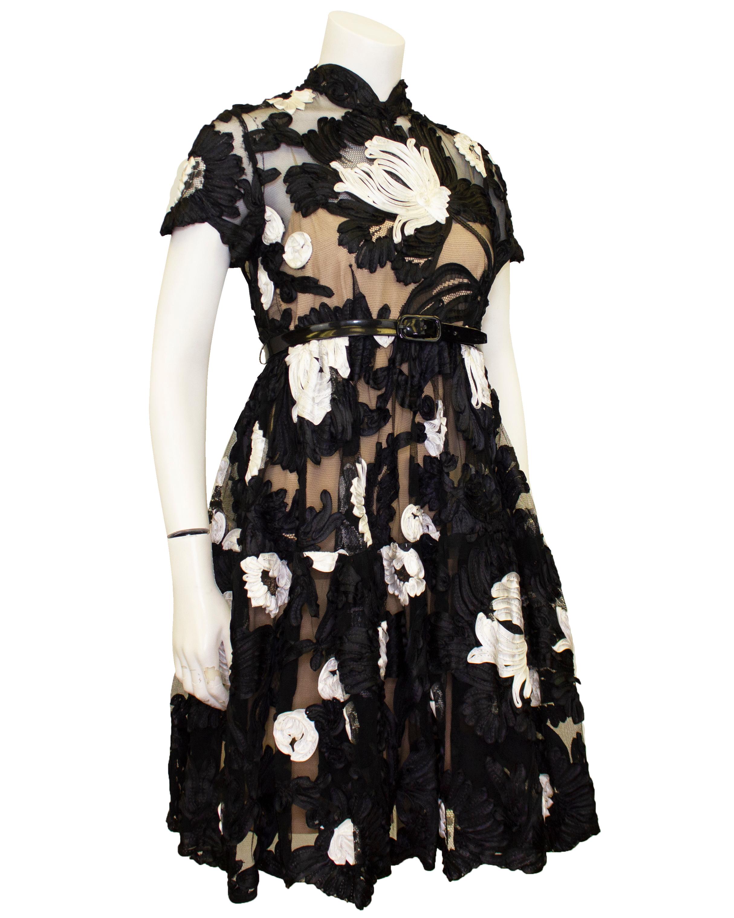 Deadstock early 1960's black lace and ribbon Bill Blass for Maurice Rentner cocktail dress. Short sleeve fitted bodice with raised collar and a swing skirt finished with a narrow black patent belt. Fully lined with a slip style liner in nude silk