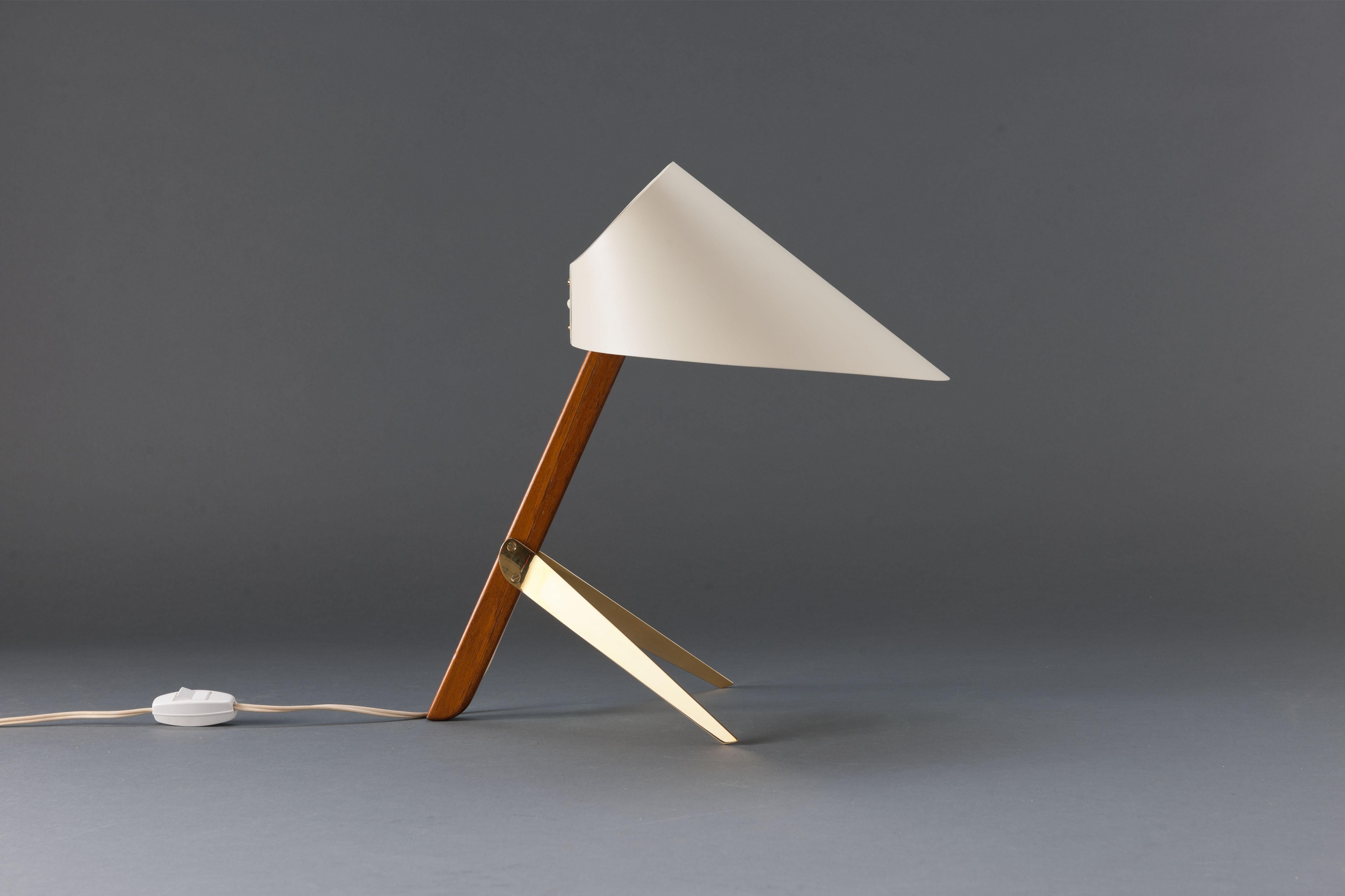 Early, 1950s execution of the 'Billy TL' table lamp by Austrian Kalmar Werkstätten.
White (matt) sharp cut cone shape steel shade on solid teak wooden stem with sharp triangular brass feet.

A beautiful strong design in remarkably good all