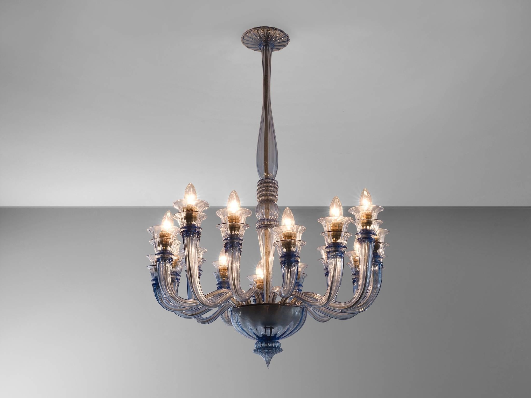 Venini chandelier, glass, Italy, 1930s.

This chandelier is blue colored glass features multiple, floral and biomorph features. These, and the colored glass are classic features of Venini. The chandelier is an eyecatcher and creates a stunning