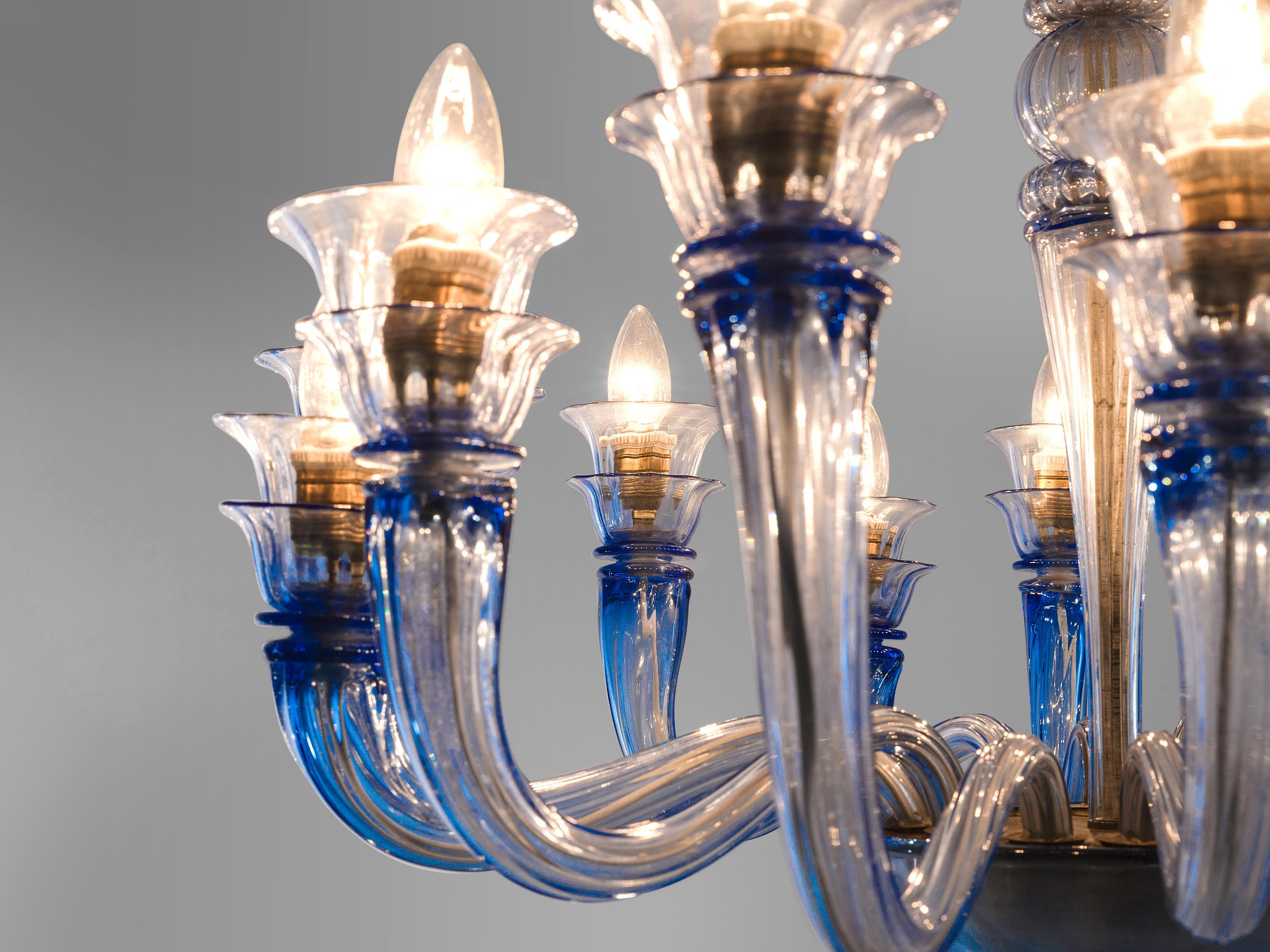 Venini, chandelier, glass, Italy, 1930s.

This chandelier is blue colored glass features multiple, floral and biomorph features. These, and the colored glass are Classic features of Venini. The chandelier is an eyecatcher and creates a stunning