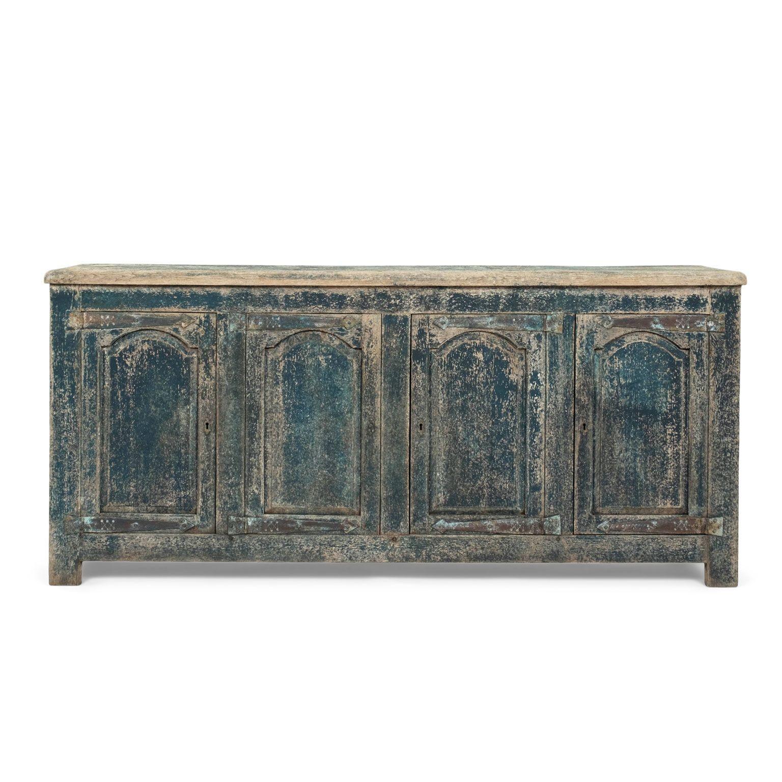 Early blue-painted four-door French enfilade circa 1700. Mortise and tenon construction. Deep, finely carved door panels. Thick plank top. Heavy iron hinges. Sturdy, stable.