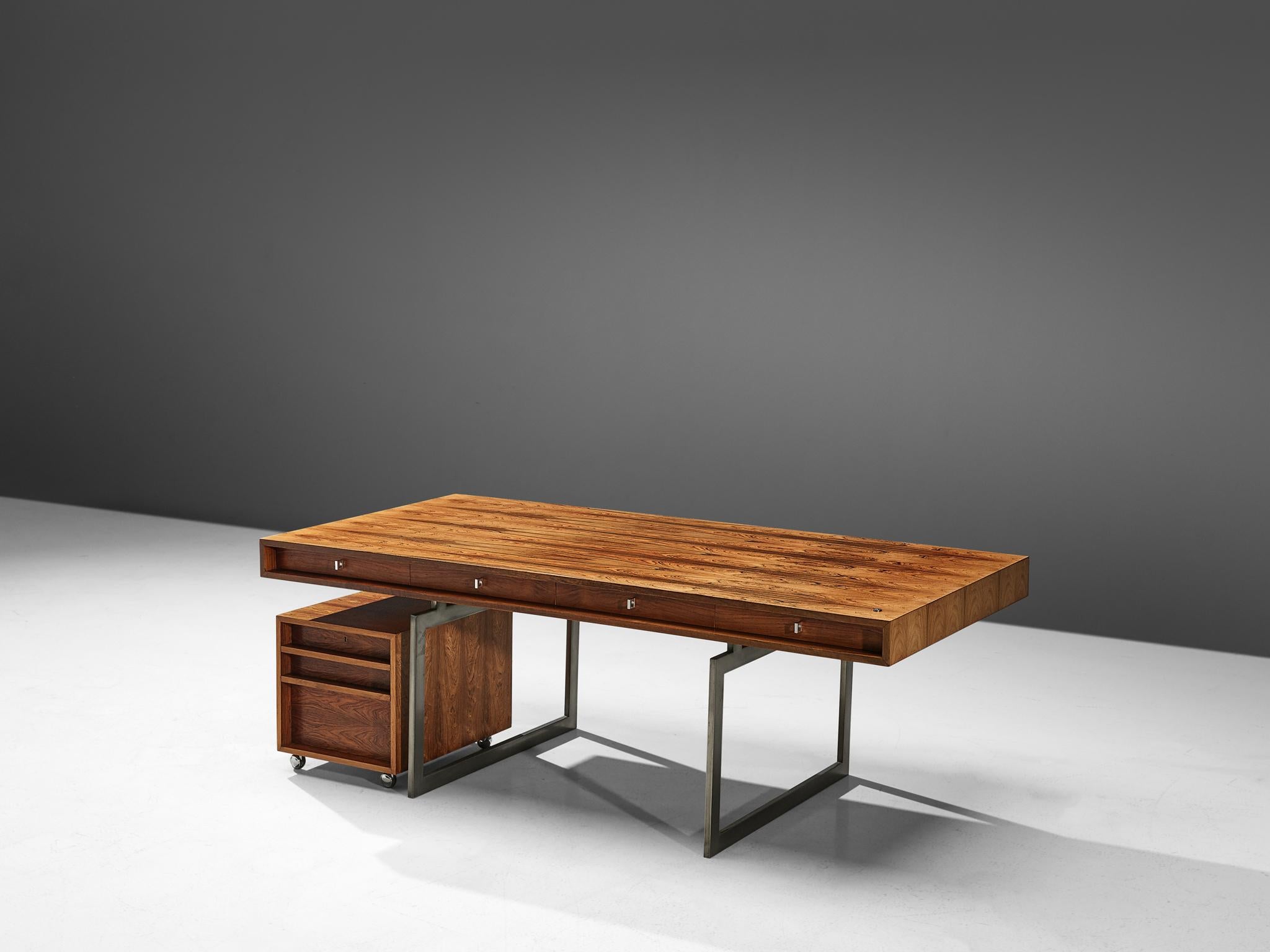 Bodil Kjaer for E. Pedersen & Søn, table model 901, rosewood and chrome steel, Denmark, 1959.

This freestanding desk in rosewood is designed by the Danish designer Bodil Kjaer. The desk can be used with multiple purposes, as a writing table, desk
