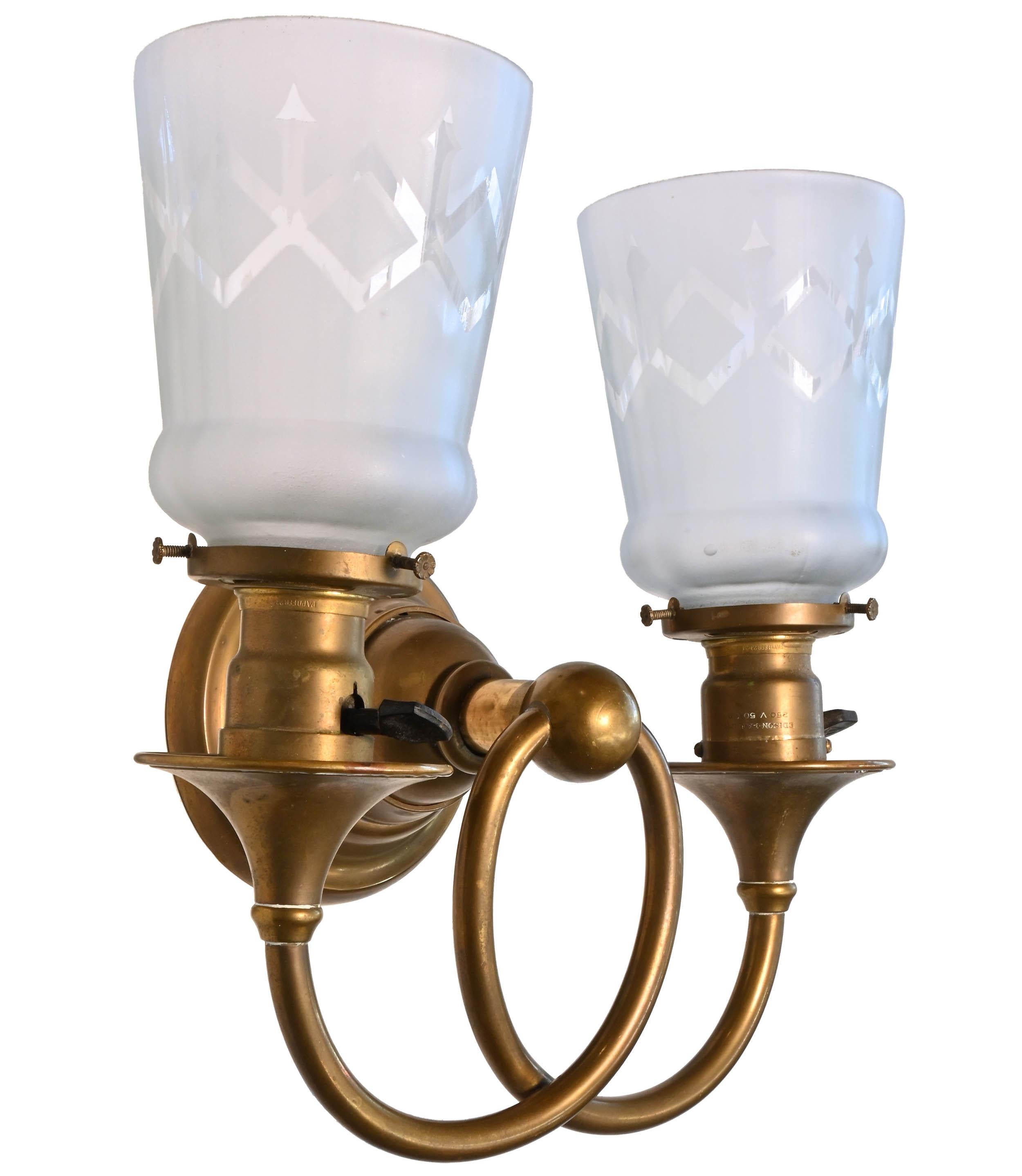 One of the sconces has a different style backplate, see photos,

Circa 1910s
Condition: Age consistent & very good
Material: Brass & Hand Etched Shades
Finish: Original
Country of origin: USA
Illumination: 2 standard Edison socket