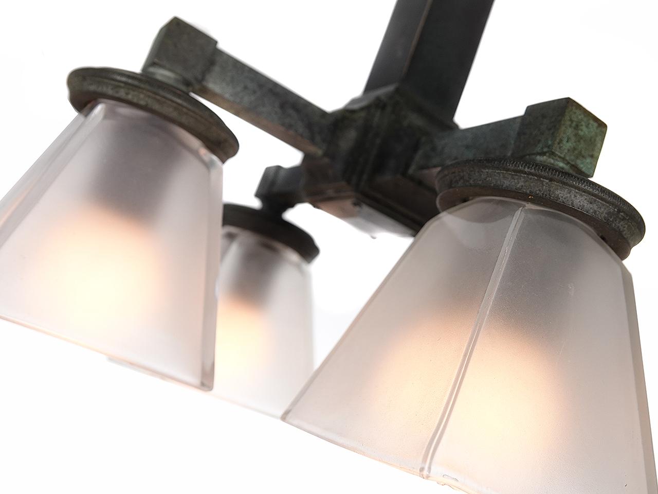 This is an authentic early 20th century cast bronze 4 light subway station ceiling lamp. Several variations of this fixture were used in New York's subway stations. This example still has the original dark finish with hints of green. We rewired all