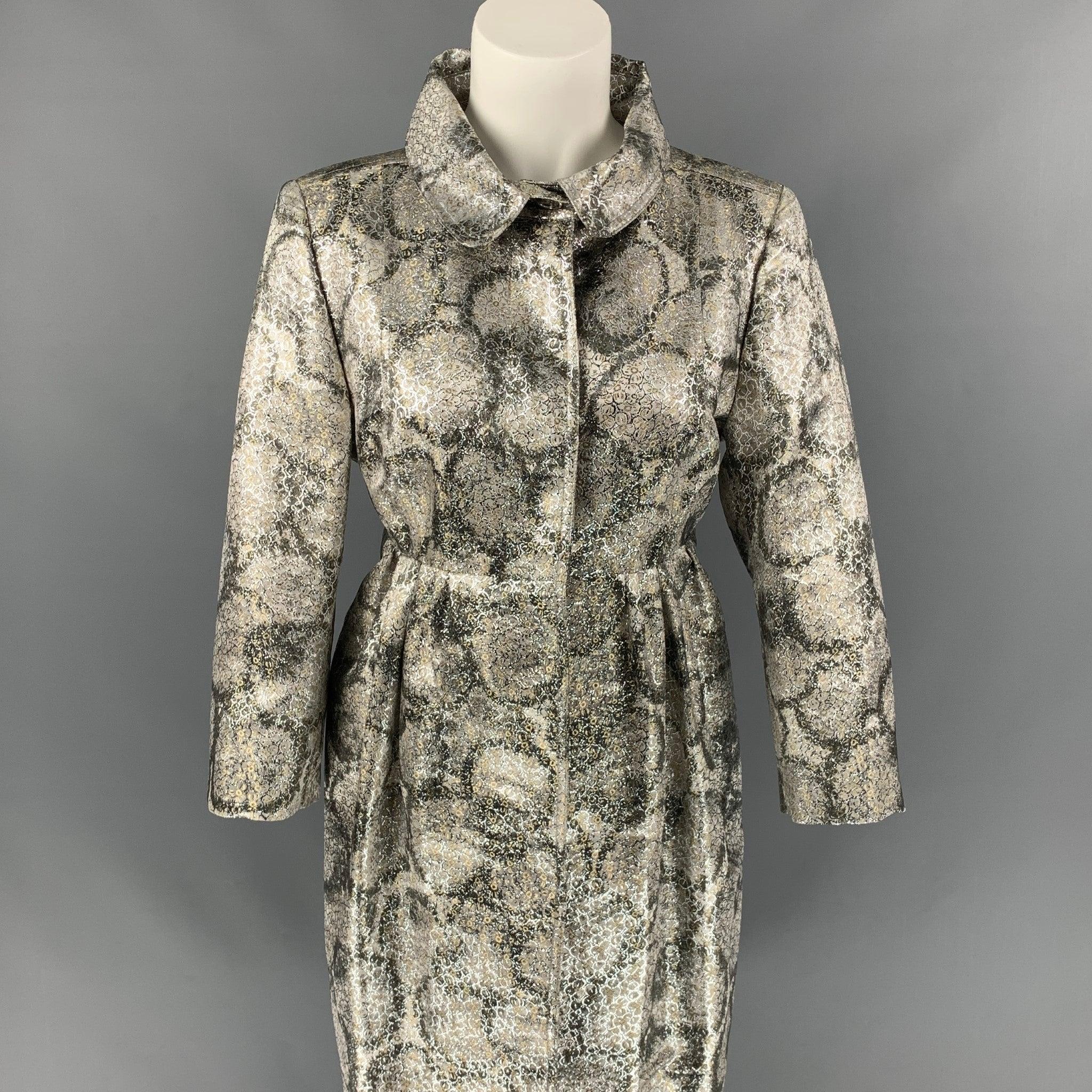 Early BURBERRY PRORSUM coat comes in a silver metallic jacquard silk blend with a full liner featuring an a-line silhouette, 3/4 sleeves, slit pockets, and a hidden snap button closure. Made in Italy.
Very Good
Pre-Owned Condition. 

Marked:  42