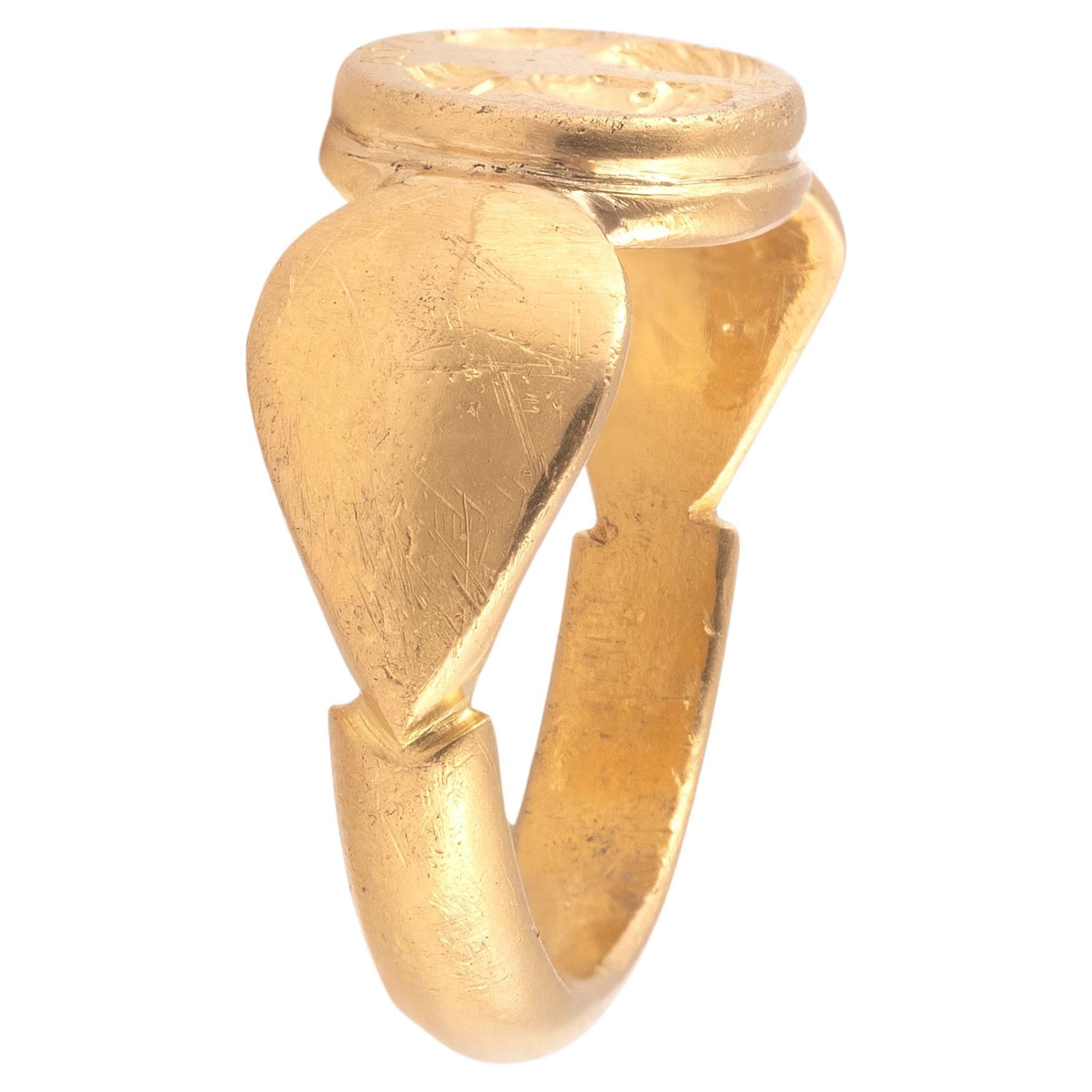 Anillo matrimonial bizantino de oro con el retrato de una pareja frente a frente con una cruz y la inscripción HVI.
El anillo continúa la tradición de llevar joyas conmemorativas del matrimonio representando a la pareja casada, una moda ya vigente a