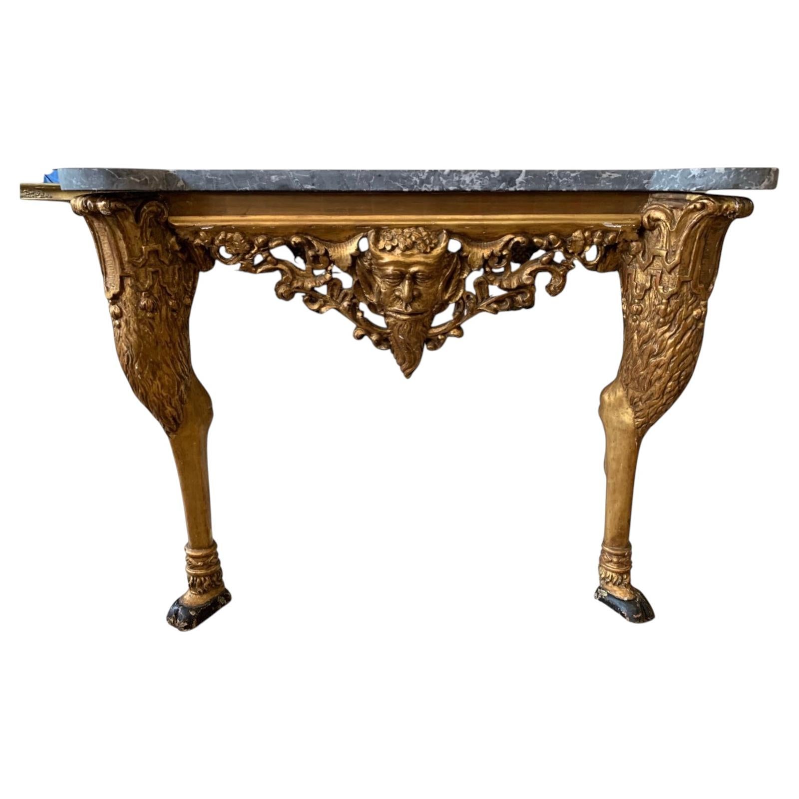 Early C19th century gilt console with Bacchus head detail and marble top For Sale